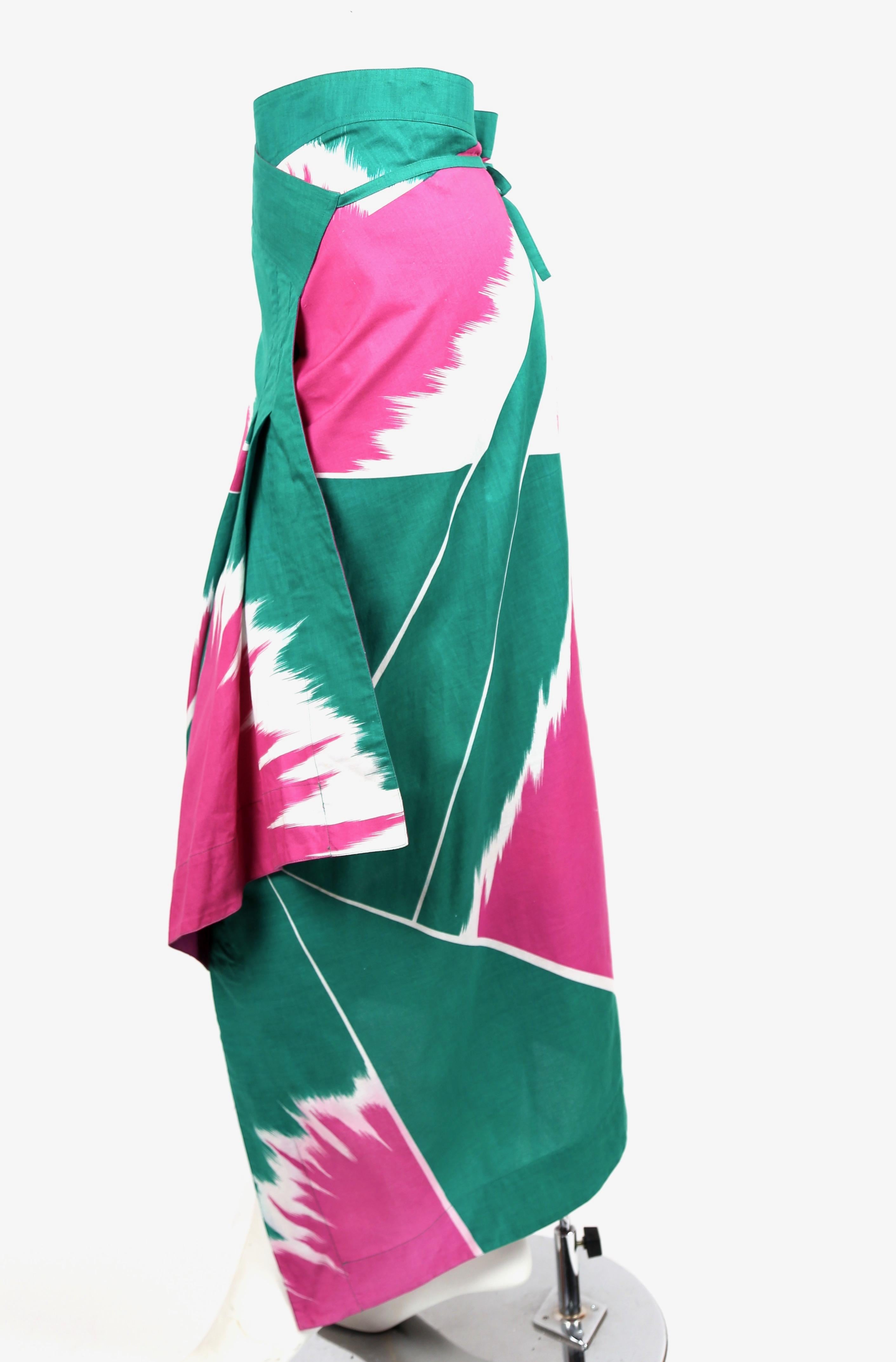 Very rare green and fuchsia printed wrap skirt designed by Issey Miyake dating to the spring of 1979. Best fits a US 4-6. Made in Japan. Very good condition. 