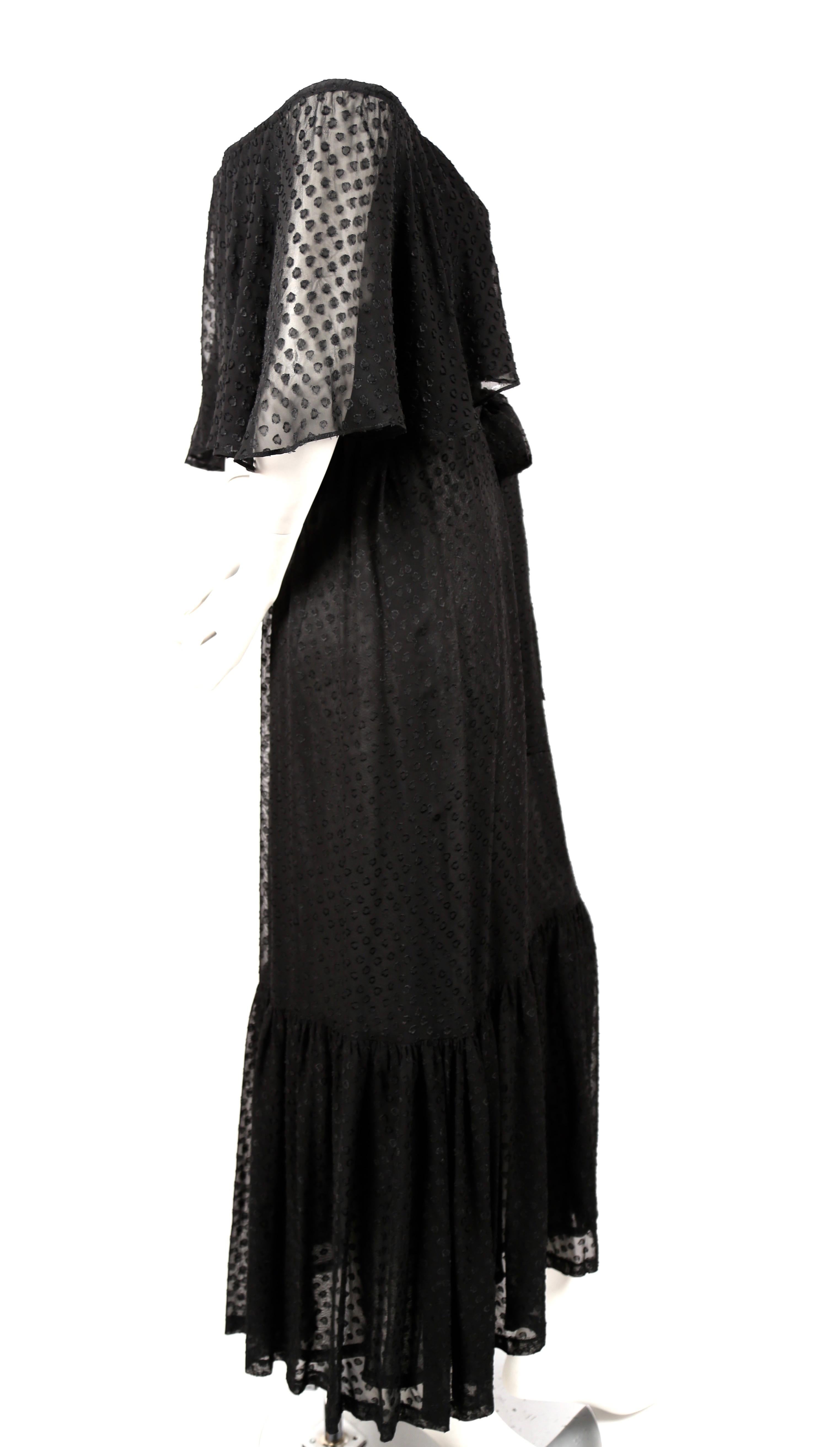 Black off-the-shoulder peasant dress with woven abstract pattern and matching belt from Yves Saint Laurent dating to the 1970's. Dress is labeled a French size 38, however it best fits a modern French 36 or 38 or US 2-6. Approximate measurements: