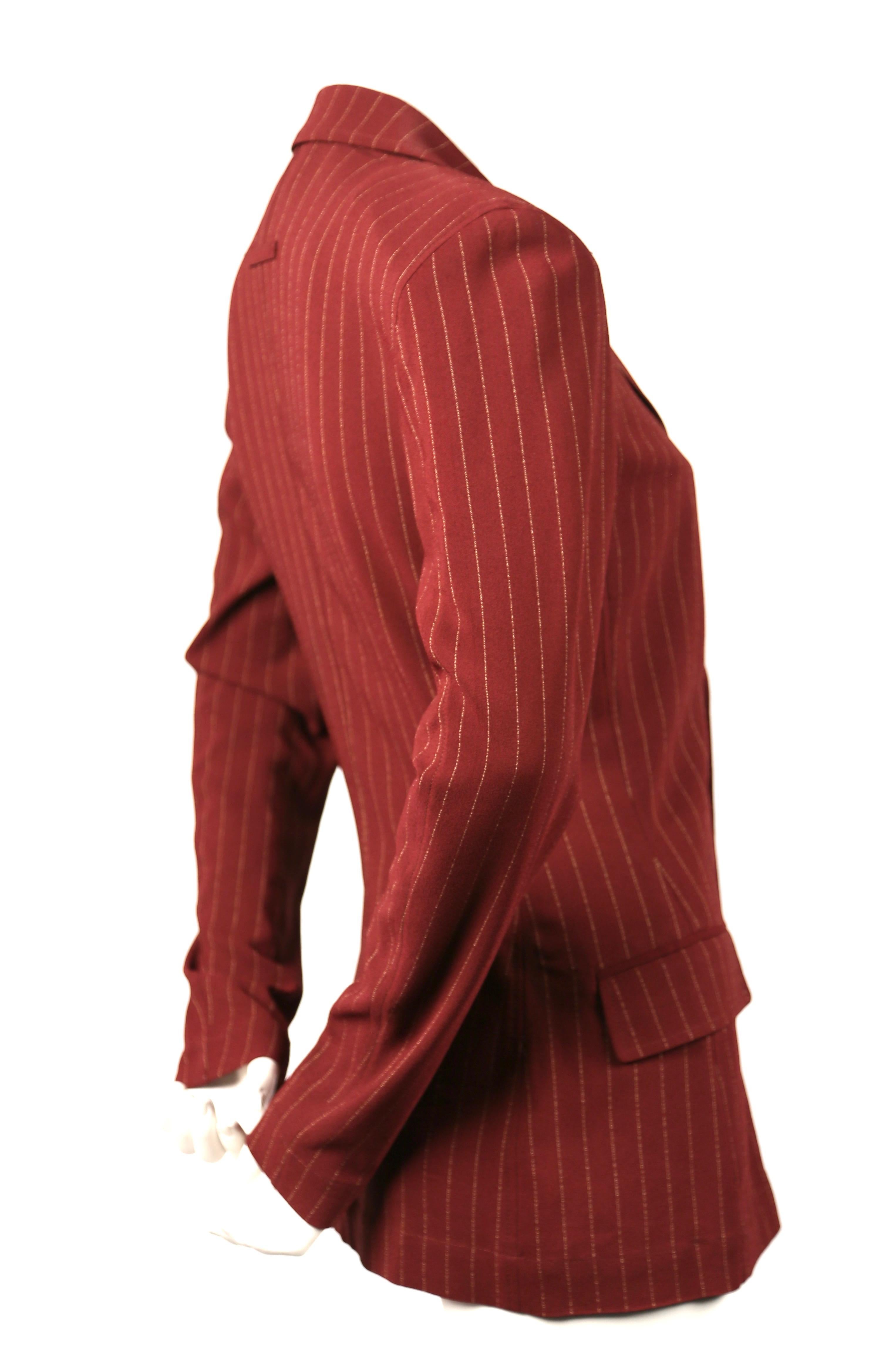 Rust pin-striped jacket designed by Jean Paul Gaultier dating to the 1990's. Slips on over the head. French size 38. Approximate measurement (unstretched): shoulder 16