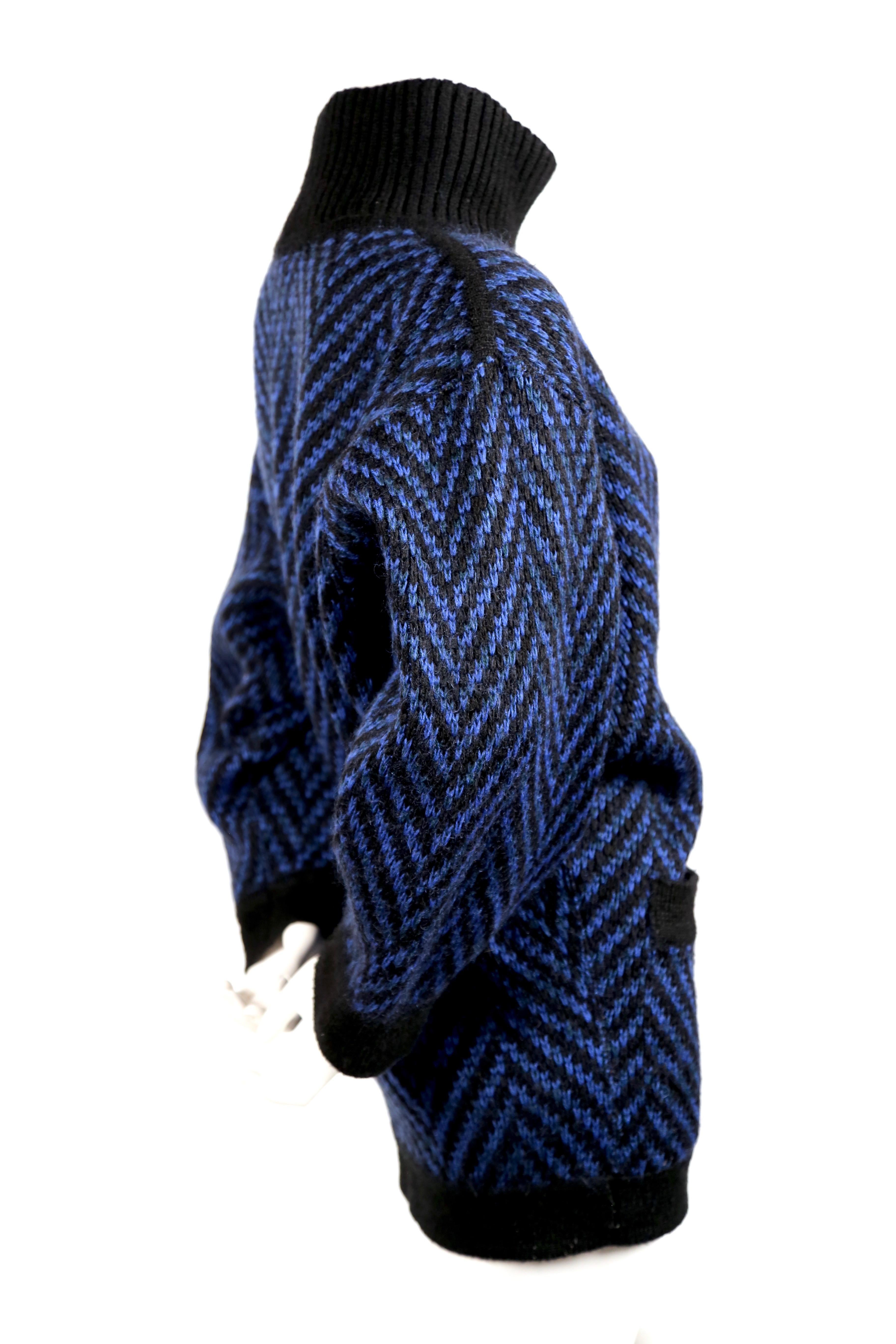 Vivid blue and jet black knit sweater dress designed by Azzedine Alaia dating to the 1980's. Labeled a French size M. Pockets at hips. Fabric content: 60% lana wool, 26% mohair, 9% acrylic and 5% nylon. Made in Italy. Very good condition. Small