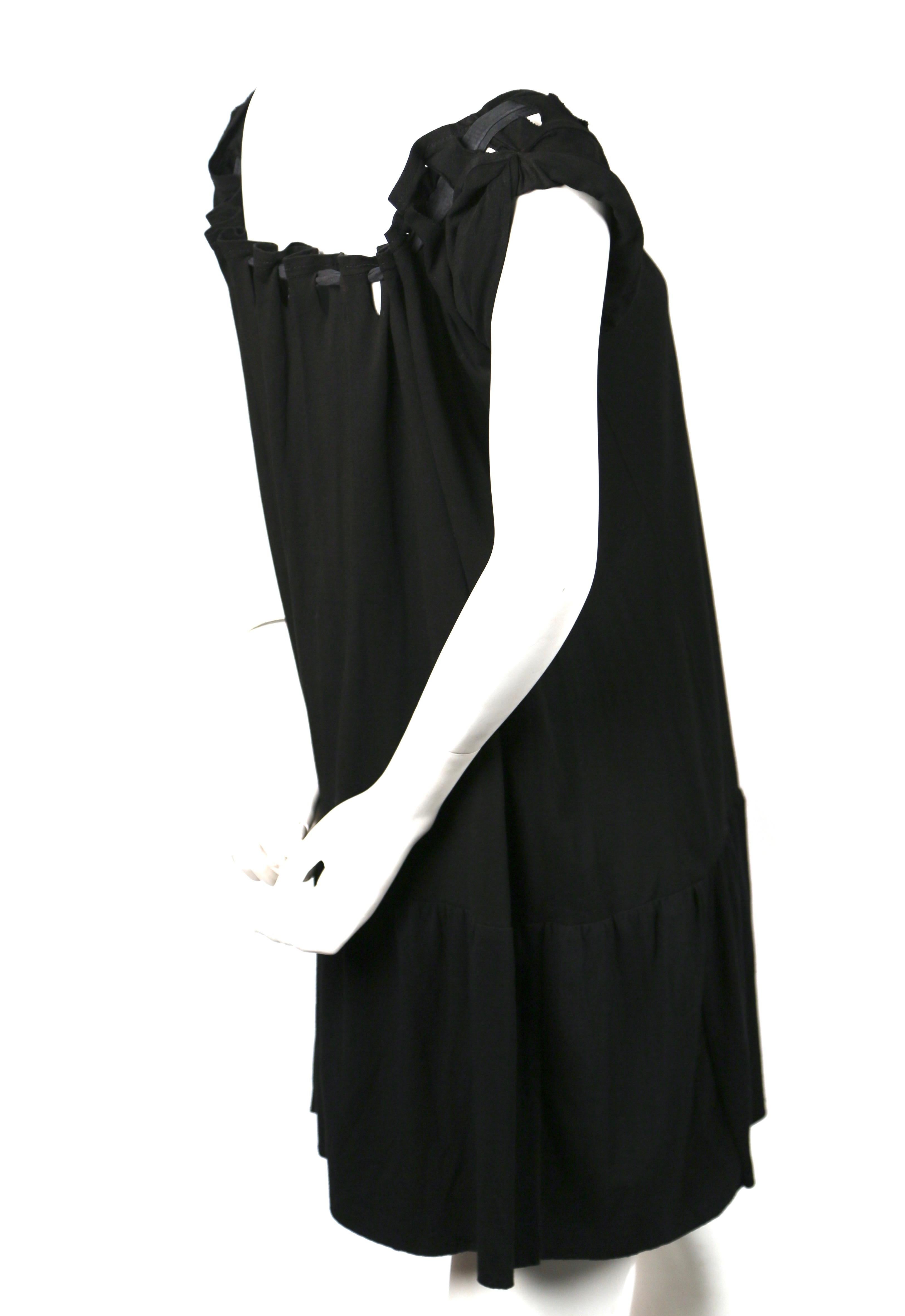 Jet-black, tiered, babydoll dress with gathered neck tie in overdyed cotton designed by Nicolas Ghesquiere for Balenciaga dating to 2001. Size S. Approximate measurements: length 33-34