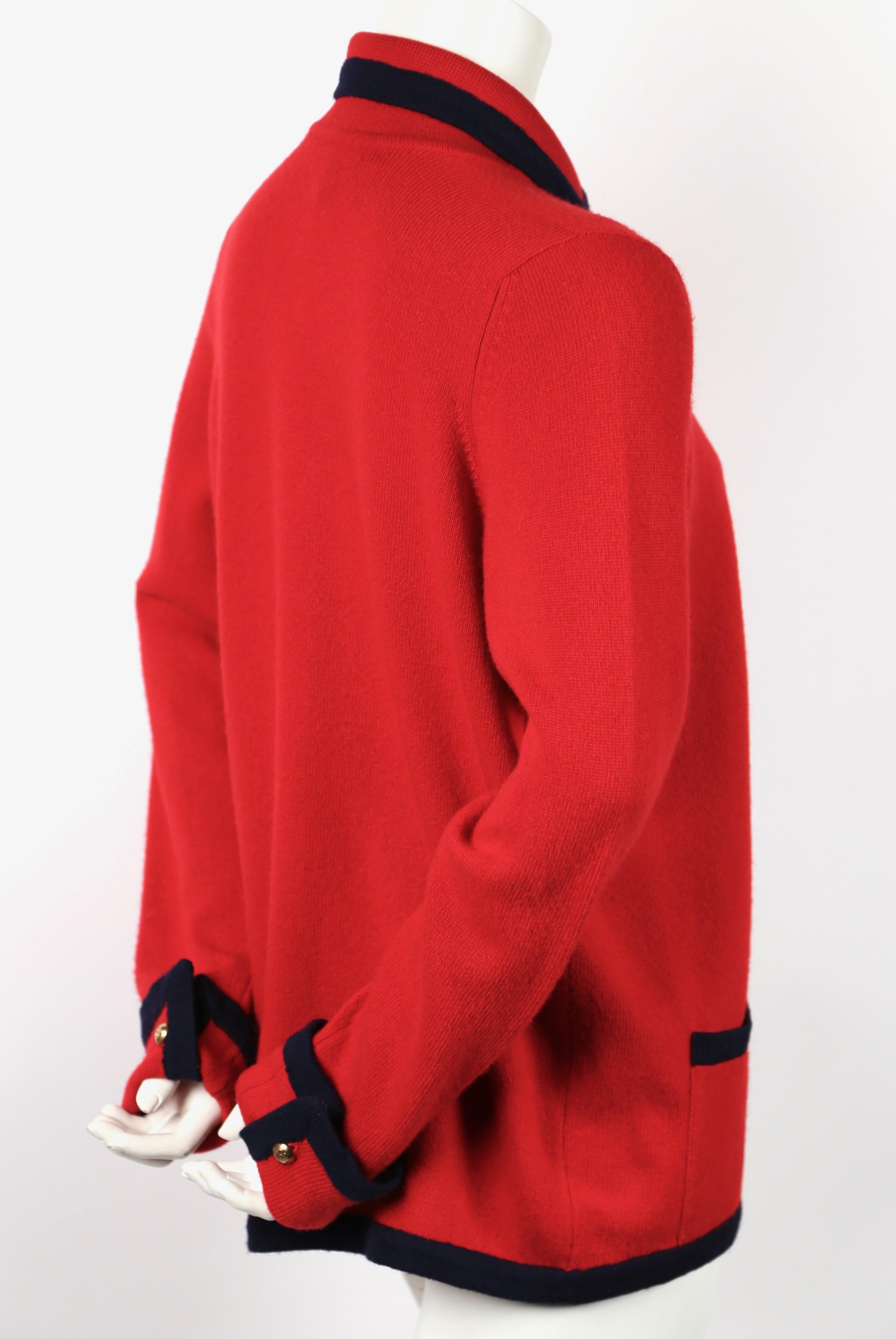 Classic red and navy blue cashmere cardigan with gilt CC buttons at neckline and sleeve cuffs from Chanel dating to the 1980's. Fits many sizes due to the open construction (Pictured on a size 2 mannequin). Sweater measures approximately,: 14