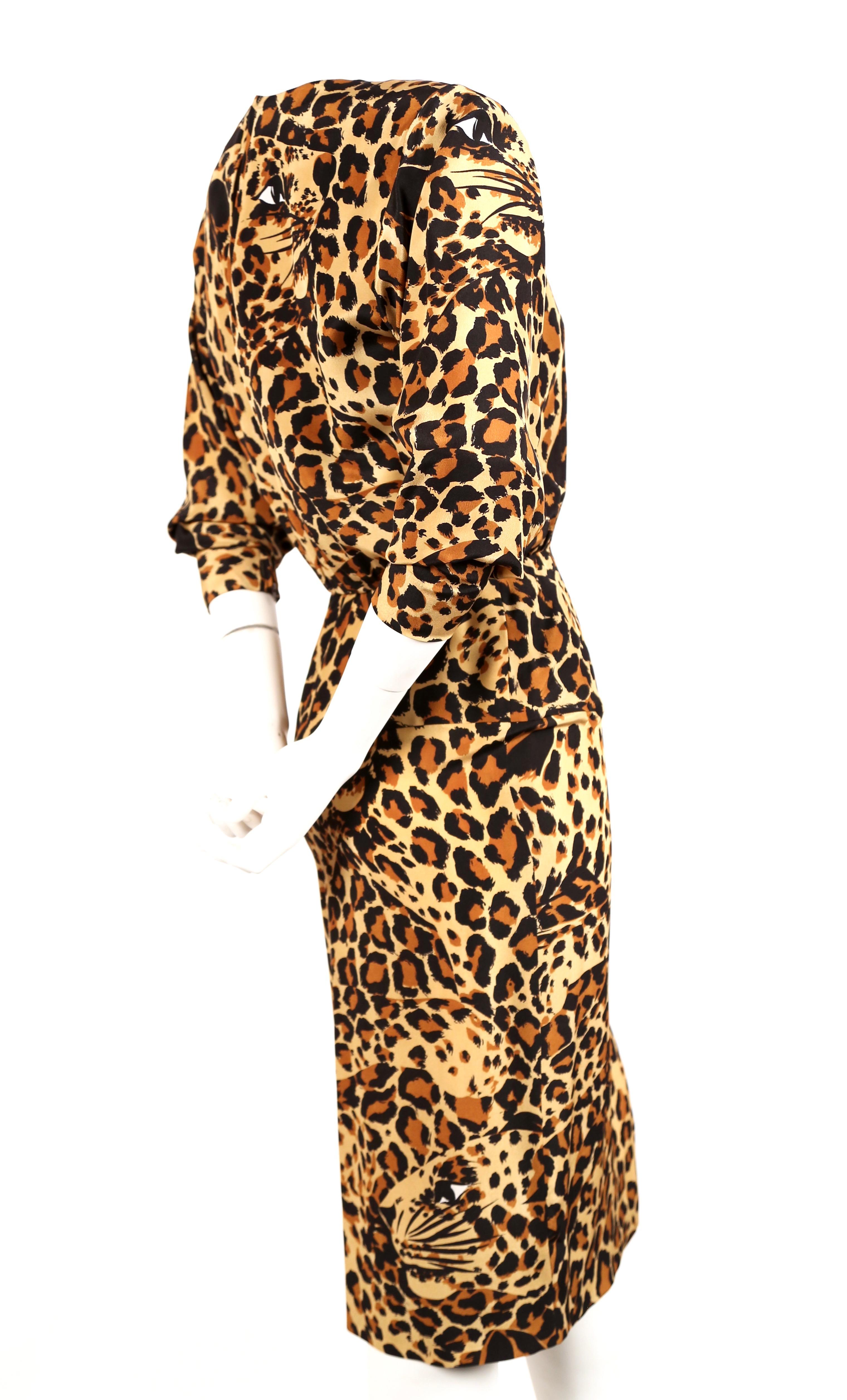 Well documented leopard printed silk dress with asymmetrical side tie from Yves Saint Laurent dating to Fall 1986 as seen on the runway. Labeled a French size 38. Approximate measurements: shoulders 16