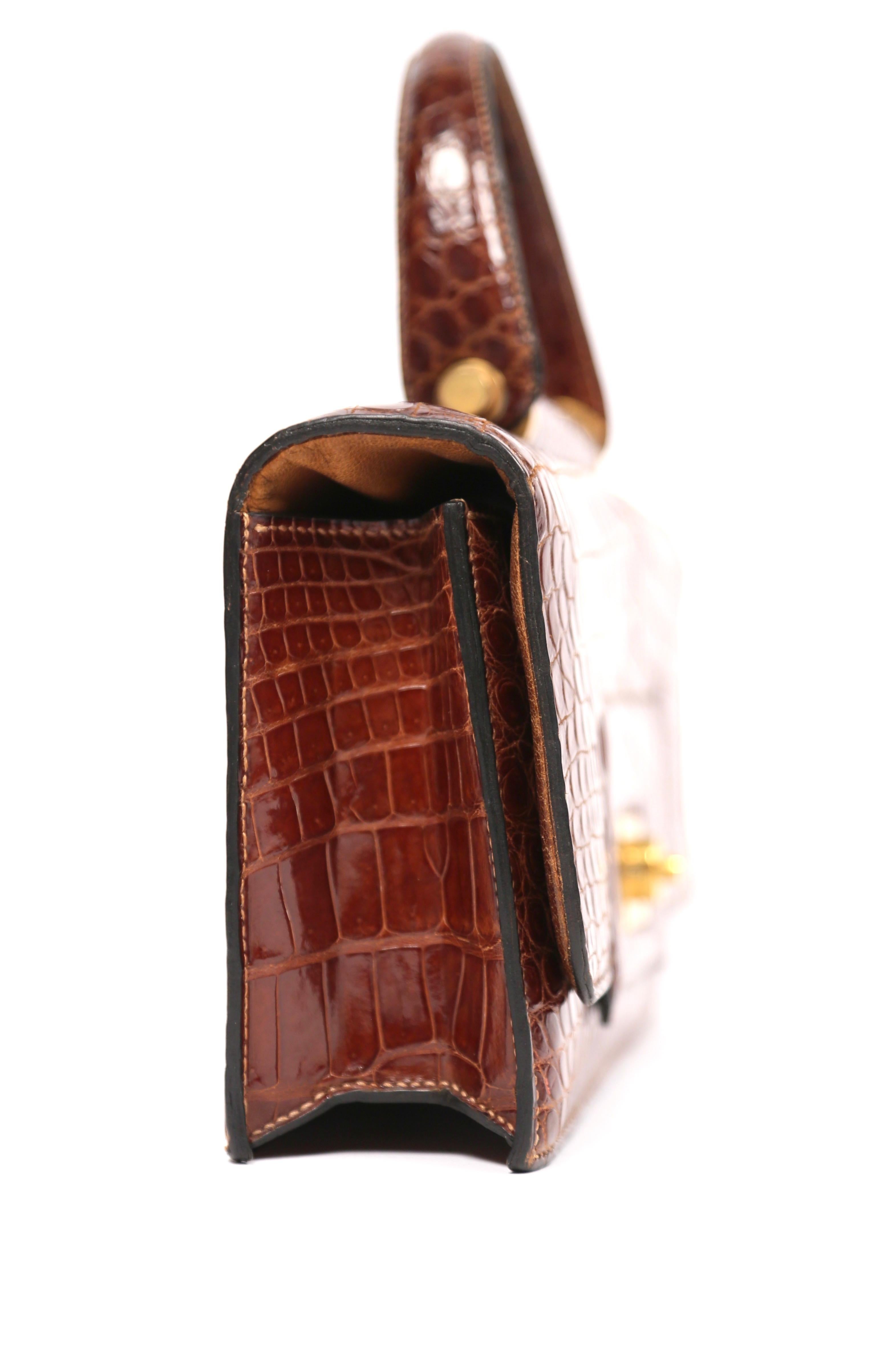 Very rare, brown crocodile bag with gilt geometric hardware from Hermes dating to the late 1940's, early 1950's. Bag measures approximately:  10.5
