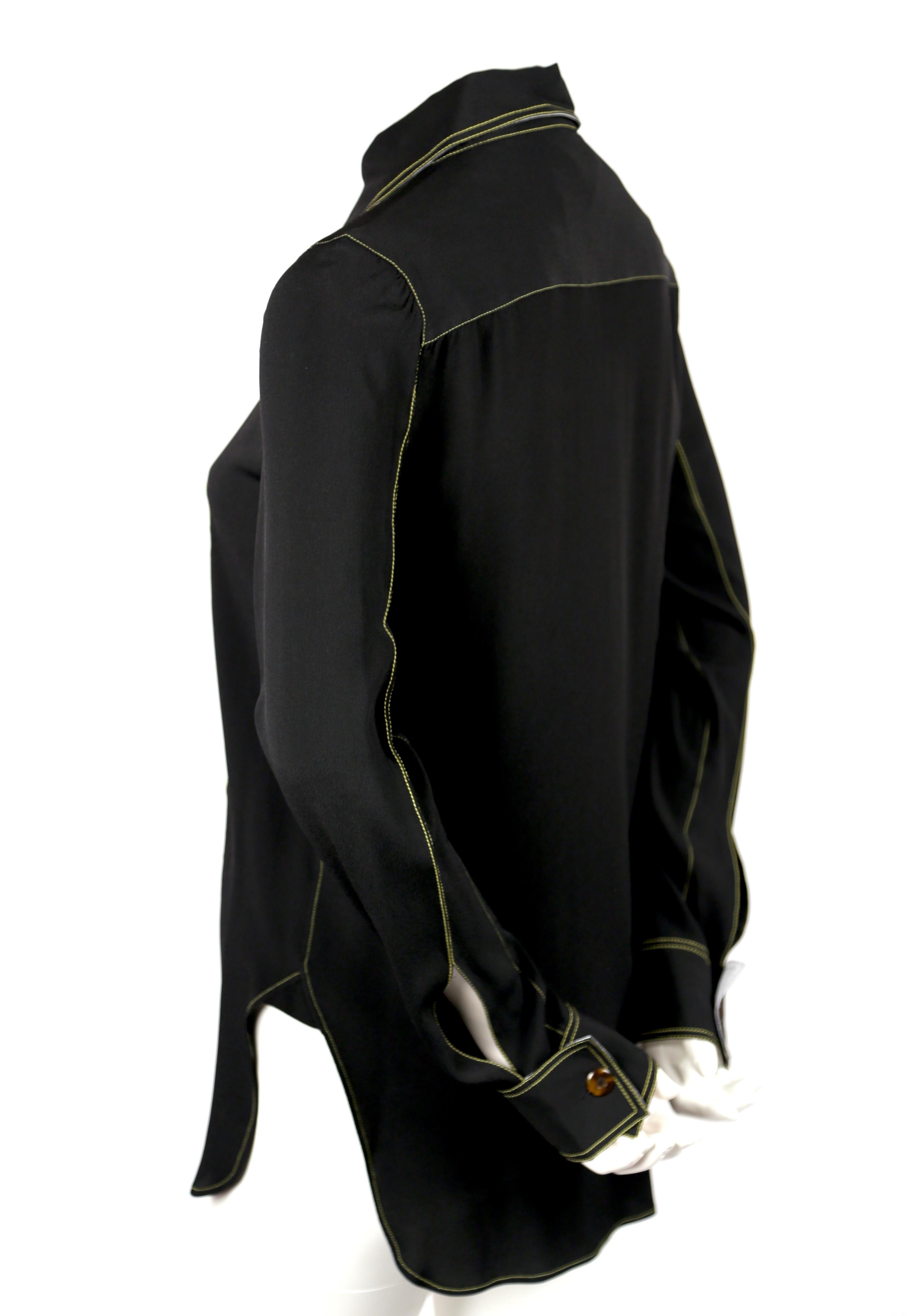Jet-black shirt with vivid yellow topstitching and tortoise buttons designed by Phoebe Philo for Celine. French size 38. Approximate measurements (unstretched): shoulder 14-15