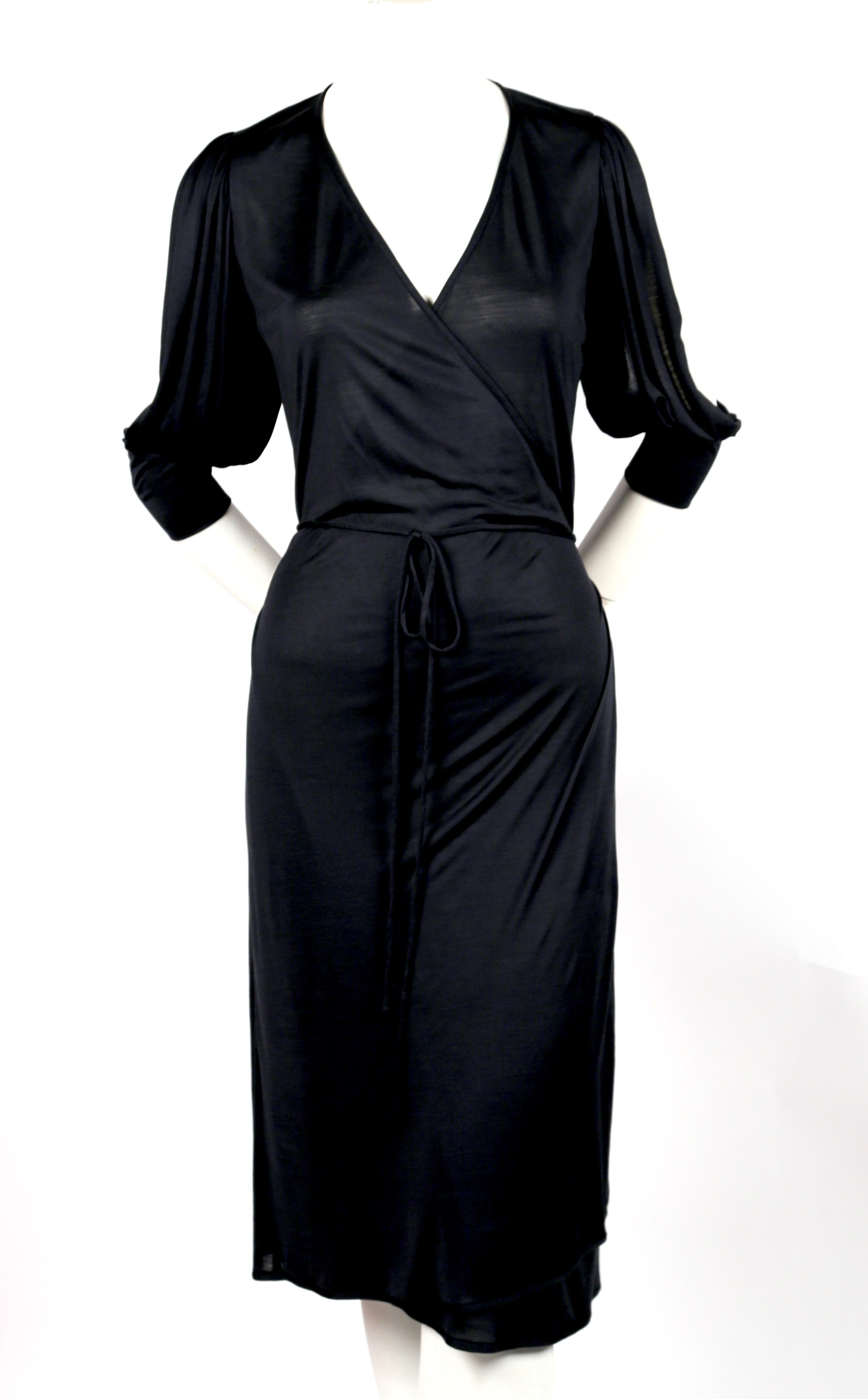 Inky black jersey, wrap dress designed by Nicolas Ghesquiere for Balenciaga dating to spring of 2000. French size 36. Bust waist and hips are adjustable due to wrap closure however this best fits a French size 36. Approximate measurements: shoulder