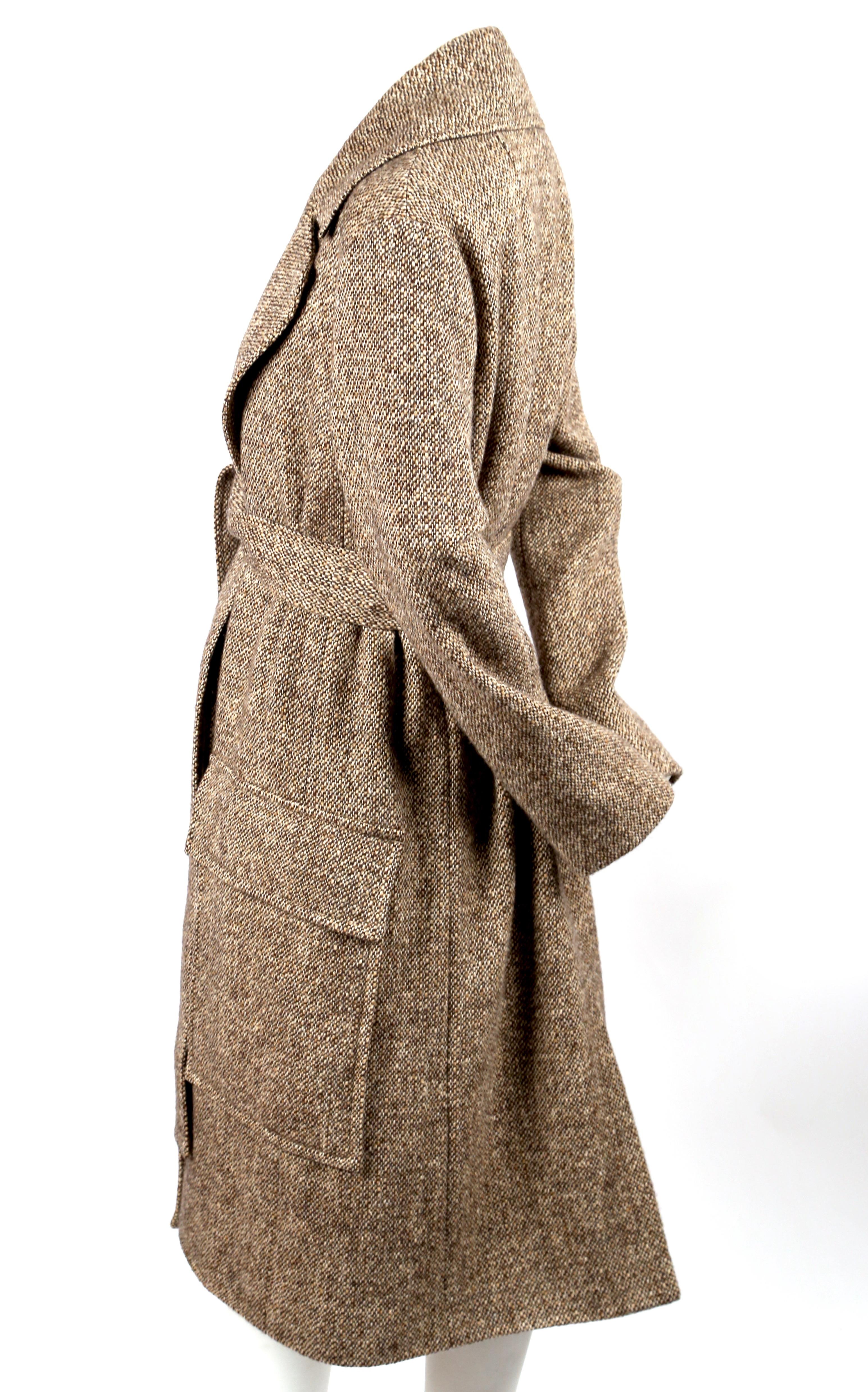 Tan, tweed wool coat with large notched collar, oversized patch pockets and waist tie designed by Phoebe Philo for Celine. French size 38. Sizing is somewhat flexible due to belt closure. Fully lined.  Made in France. Fabric content: 100%