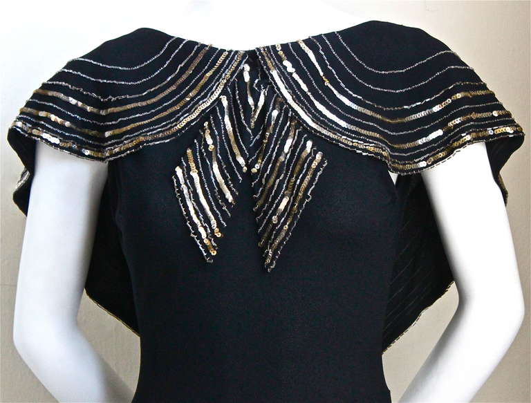Black crepe bias cut gown with beaded and sequined capelet dating to the 1930's.  Fits a US size 2 or 4. Approximate measurements are: bust 30