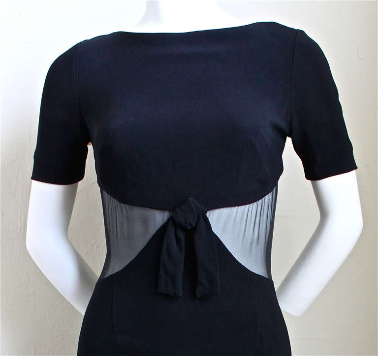 Fitted black dress with sheer waist and bow detail from Balenciaga dating to fall of 1996 exactly as seen on the runway. Labeled a French size 40 however this dress is very small and would fit a size 4 at largest. Approximate measurements: shoulders