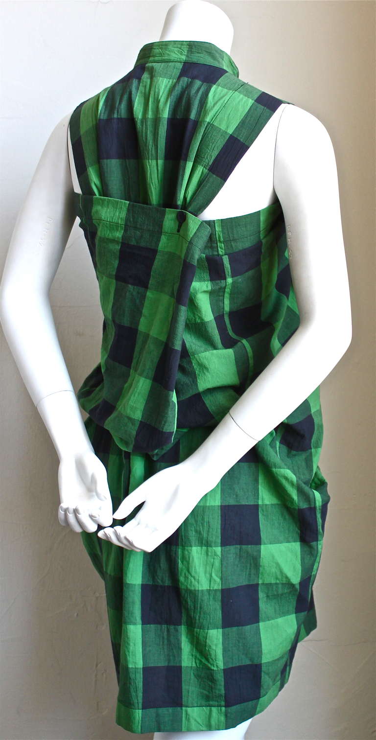 Very unusually vivid green and black checked mini dress with draped back from Issey Miyake dating to the 1980's. Dress can be worn a number of ways. Labeled a size M and measures and 35