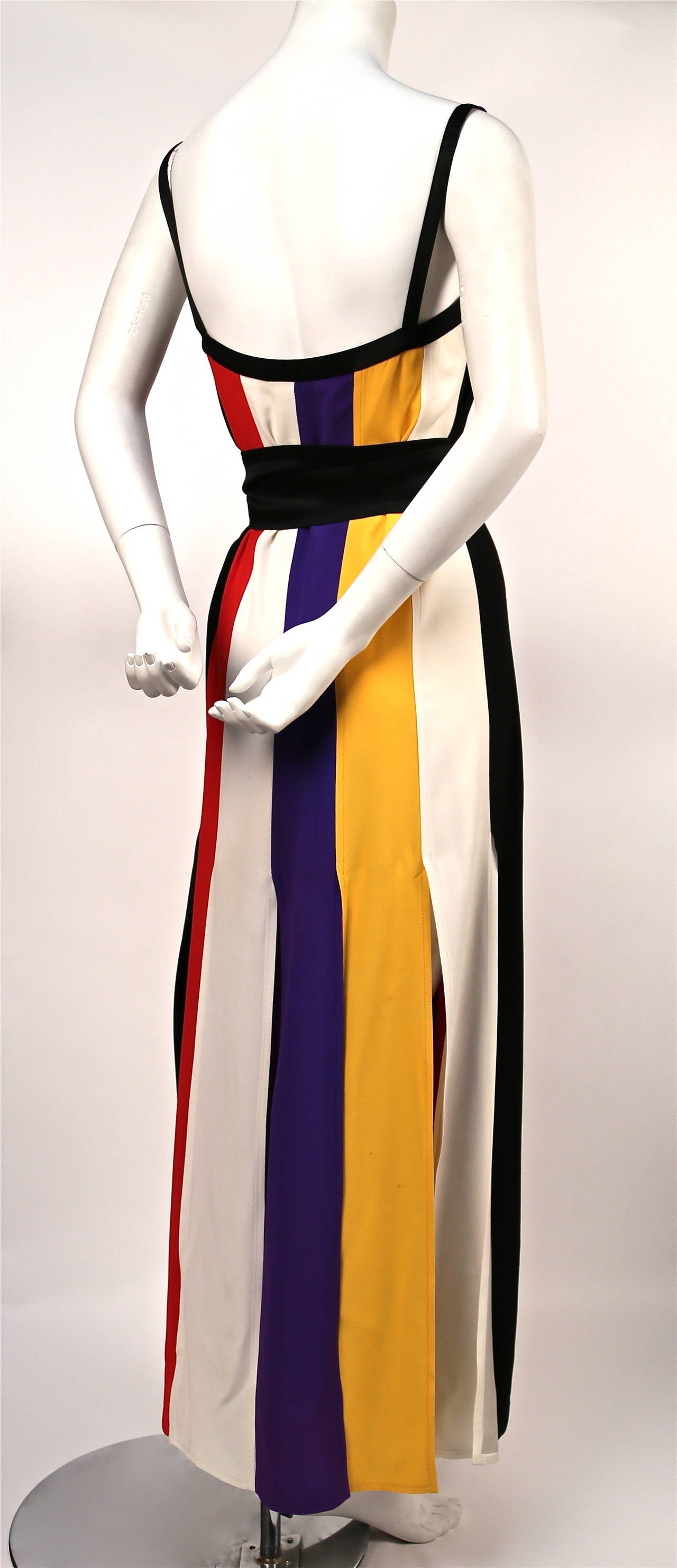 Colorful striped crepe dress with black satin straps, square neckline, carwash hemline and extra long black satin belt from Yves Saint Laurent dating to the 1970's. Labeled a French size 40 although this best fits a US 4-6. Approximate measurements:
