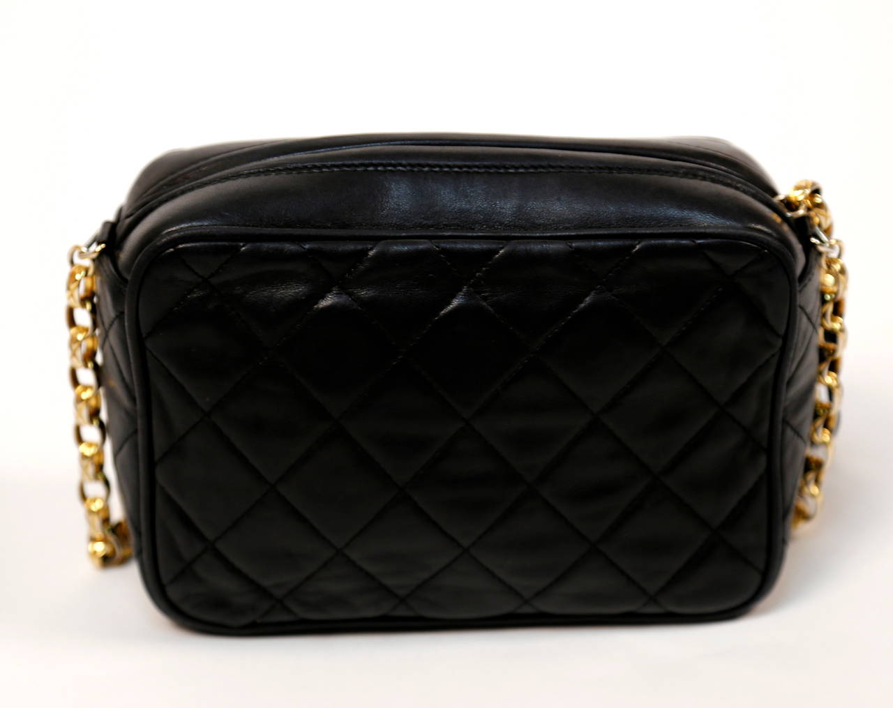 Jet black quilted lambskin leather bag with tassel, long gilt chain and 'CC' turn lock closure from Chanel dating to the early 1990's. Approximate measurements: width 7