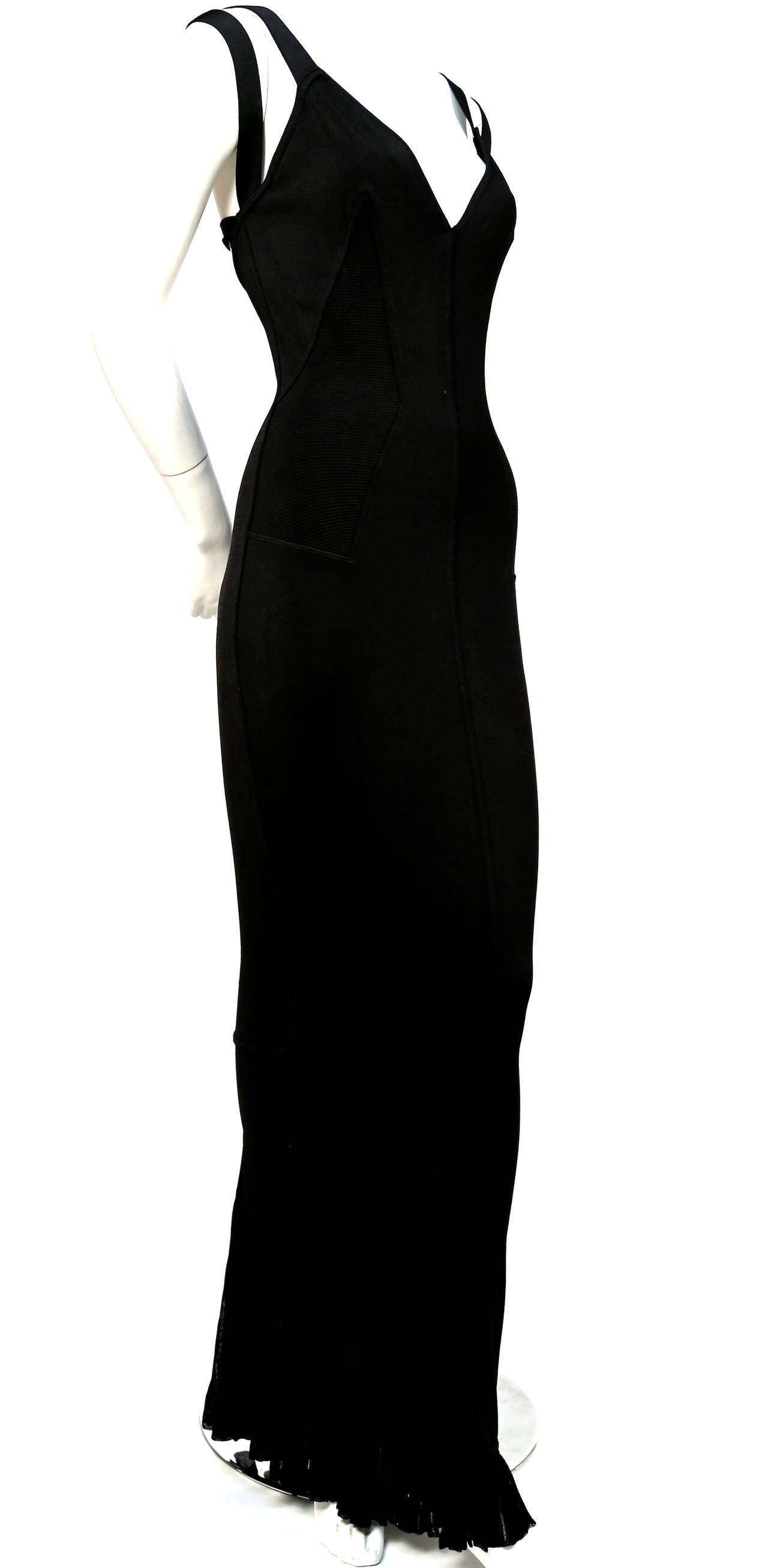 Very rare jet black long dress with pleated fishtail hemline from Azzedine Alaia dating to 1990. Size 'S'. Approximate measurements: bust 29