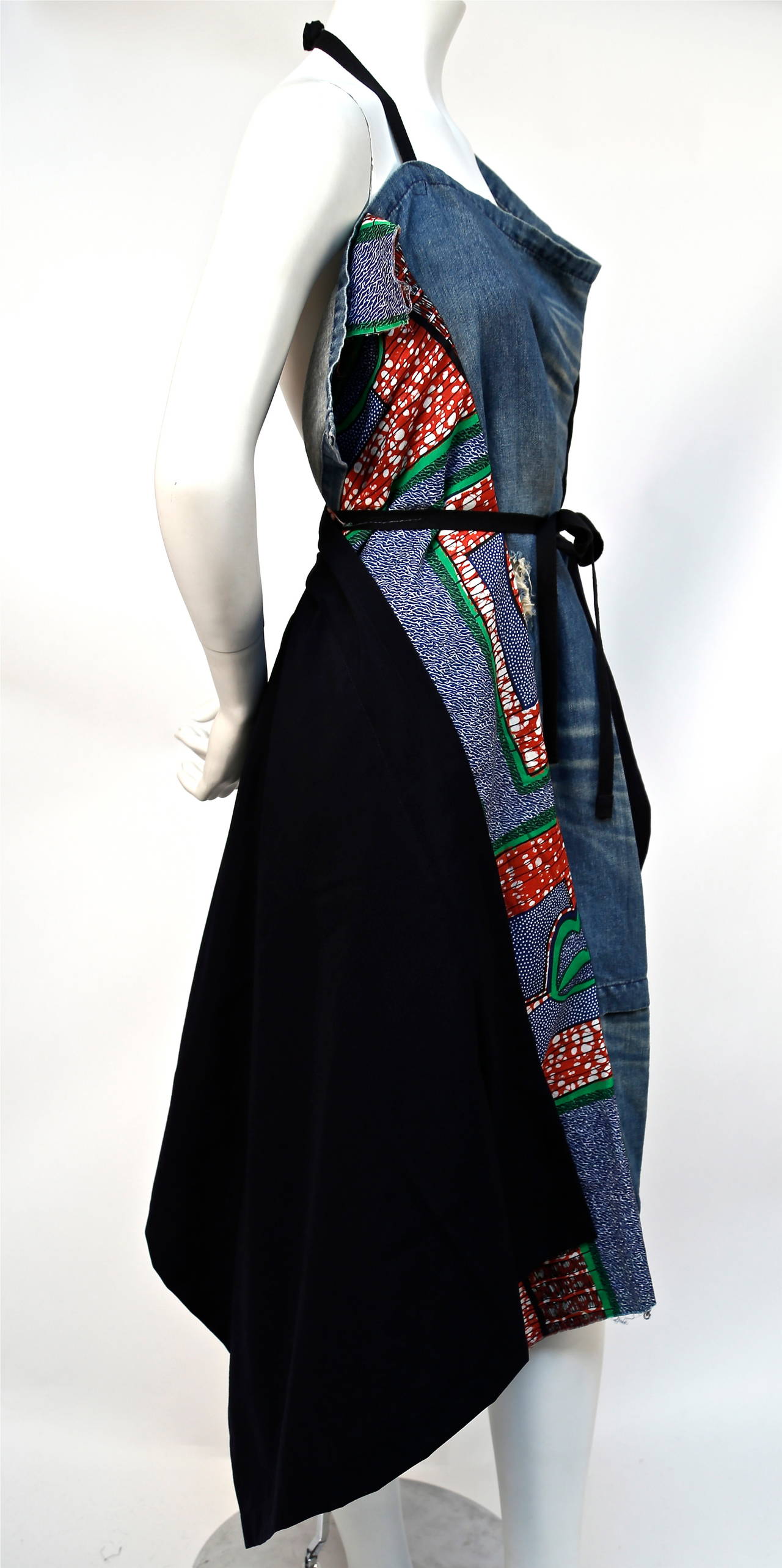 African printed cotton and distressed denim wrap apron dress from Junya Watanabe as seen on the runway for spring of 2009. Size 'S'. Made in Japan. Secures at waist with black tie.  Dress has intentionally frayed areas and raw hemline. Excellent