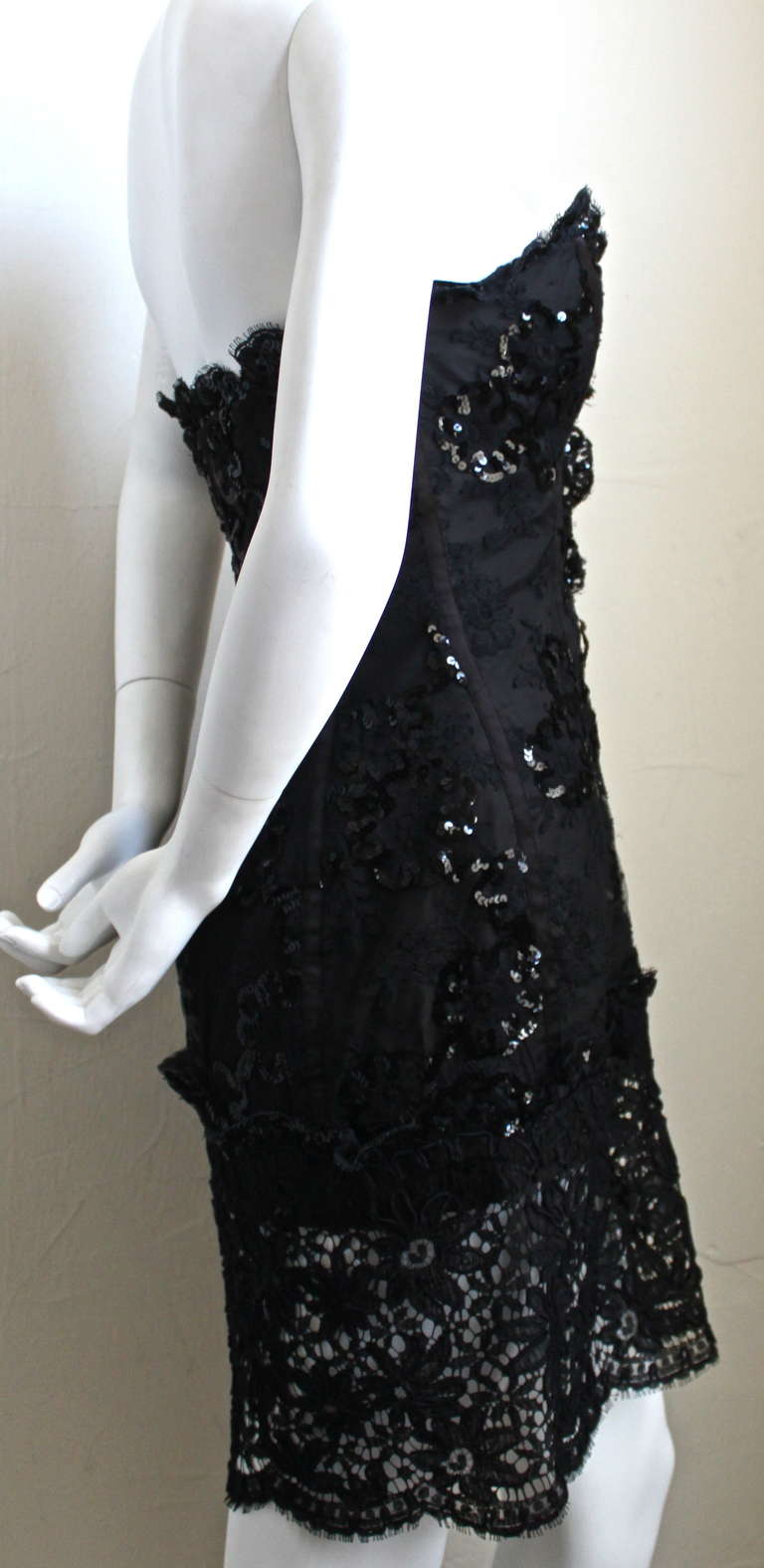 Beautiful lace mini dress with sequins, bottom sheer panel and satin trim from Yves Saint Laurent dating to Spring of 1992. Dress is labeled a French size 38; however it would better fit a modern day size 36. Approximate measurements are: bust 31