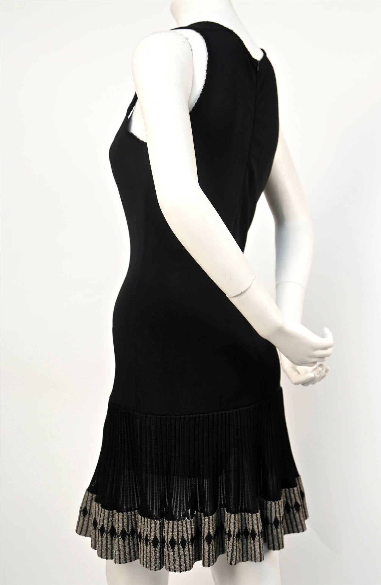 Very rare jet black dress with scalloped trim and semi sheer skirt with decorative diamond embroidered hemline from Azzedine Alaia dating to the early 1990's, Dress is labeled a size S however this could easily fit a size M. Zips up back with