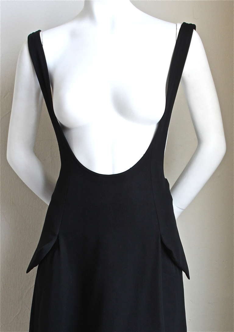 Black wool jumper with unique front flap pockets from Yohji Yamamoto dating to the 1980's. Labeled a size 'S', however this would fit either a size S or M. Approximate measurements are: opening at waist 30