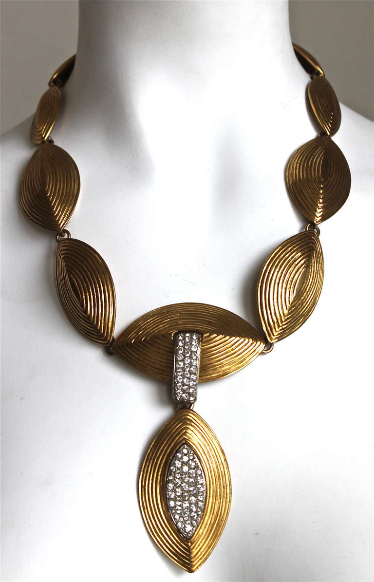 Dramatic gilt necklace with clear crystals from Yves Saint Laurent dating to the 1980's. Necklace measures 21.25