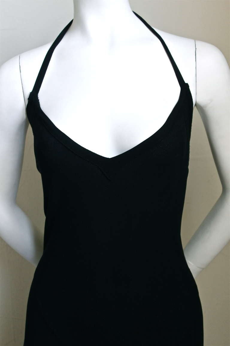 Jet black moss crepe bias cut gown with deep V front and back from Ossie Clark for Quorum. Beautiful topstitching detail around top. Labeled a UK 14 although this dress best fits a US 6-8. Dress is difficult to measure because it is cut on the bias