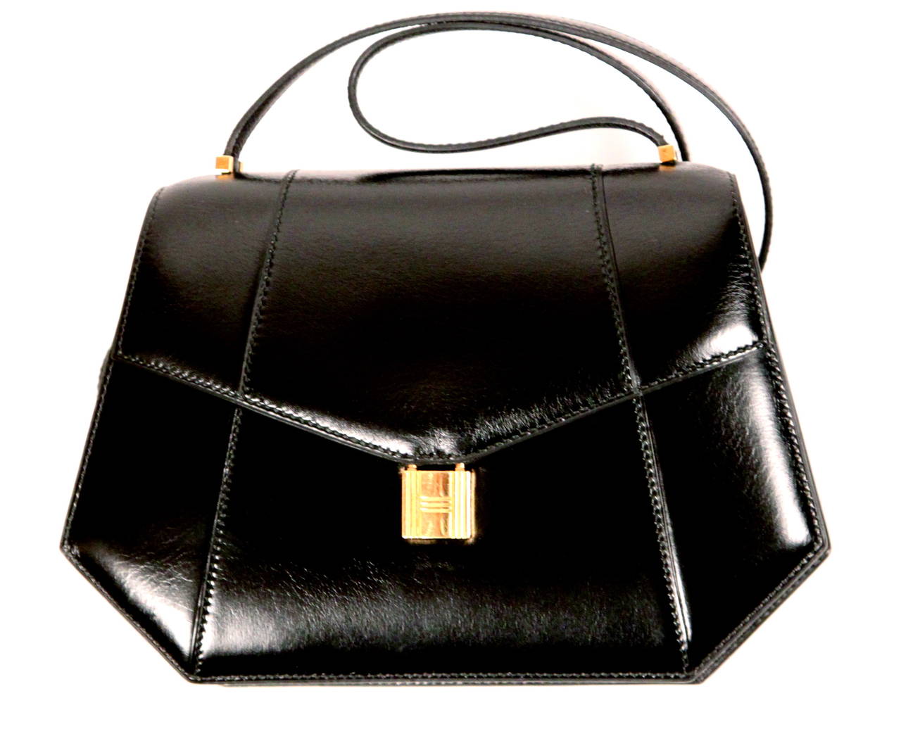 Very rare jet black box leather bag with gold 'padlock' closure from Hermes. Can be used for day or night. Approximate measurements are: 9