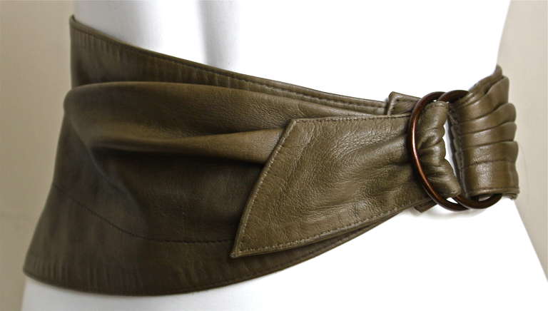 Olive green butter soft rushed belt with antiqued brass size buckle from Azzedine Alaia dating to the 1980's. Belt size is listed as a French 40 however it fits a size 2-6 (24-26