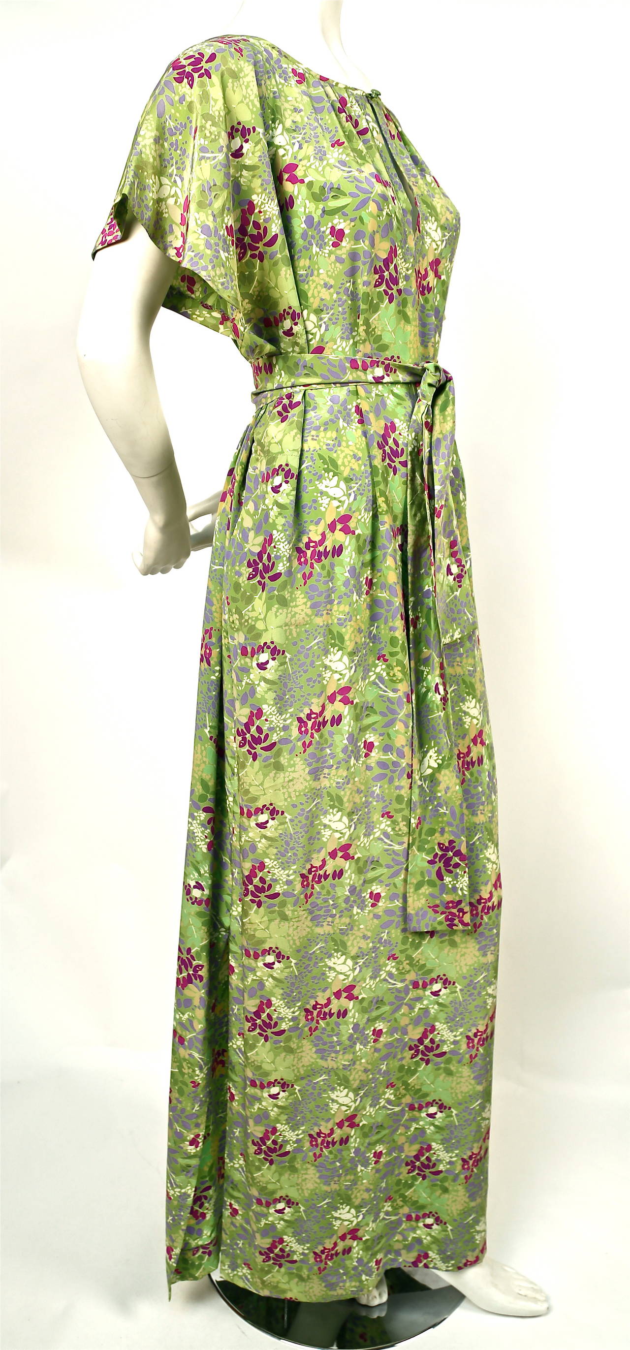 Very rare floral silk caftan gown with matching belt by Yves Saint Laurent dating to the 1970's. Labeled a French size 34 however this will easily fit up to a US 8 due to the cut. Pockets at hips. Made in France. Excellent condition.