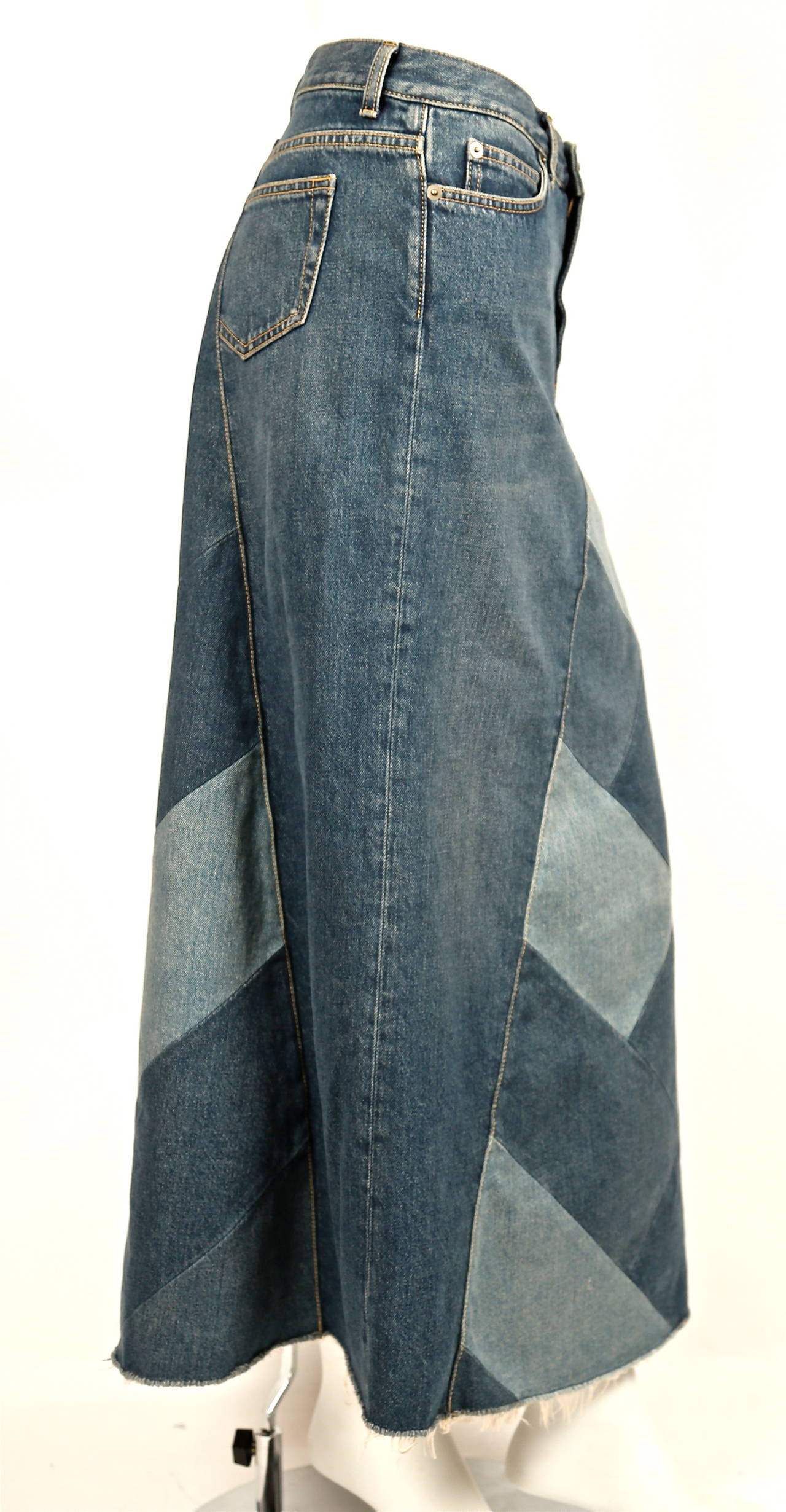 Blue cotton patchwork denim skirt designed by Hedi Slimane for Saint Laurent dating to summer of 2015. Skirt has a button & zip fastening, a five pocket design, belt loops, an a-line shape and a straight hem. Labeled a size 27. Approximate