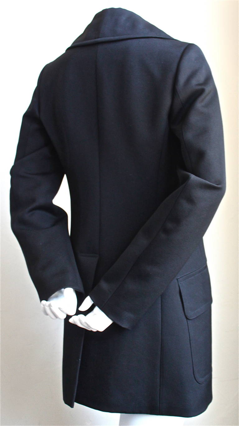 Classic jet black wool gaberdine coat with double breasted closure from Azzedine Alaia. French size 38. Approximate measuremetns: shoulder just over 14