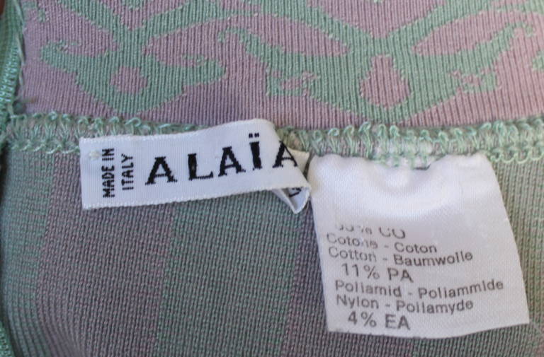 Very important, iconic, pale green and pink striped mini dress with off the shoulder trim from Azzedine Alaia dating to 1992. The dress fits a size XS or S   The mannequin is a size 2 and it was a perfect fit.  Approximate un-stretched measurements