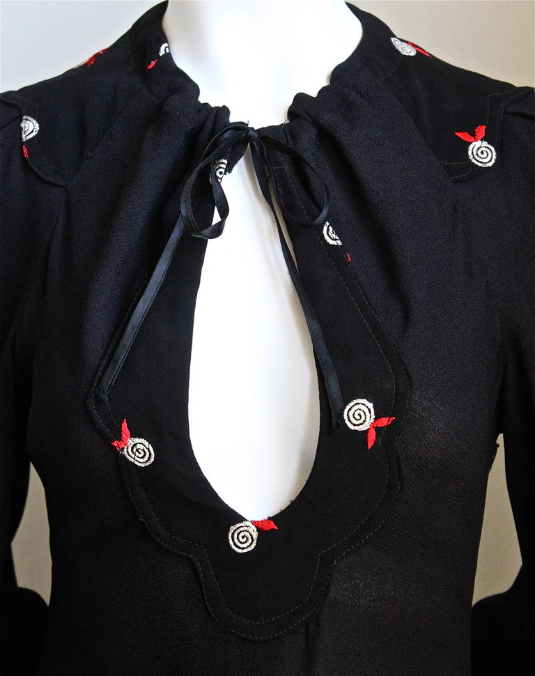 Jet black moss crepe long dress with long billowy sleeves, plunging keyhole neckline and embroidery designed by Ossie Clark for Radley dating to the 1960's. Dress is labeled a size '38', although it fits a US 4-6. Measurements are somewhat difficult