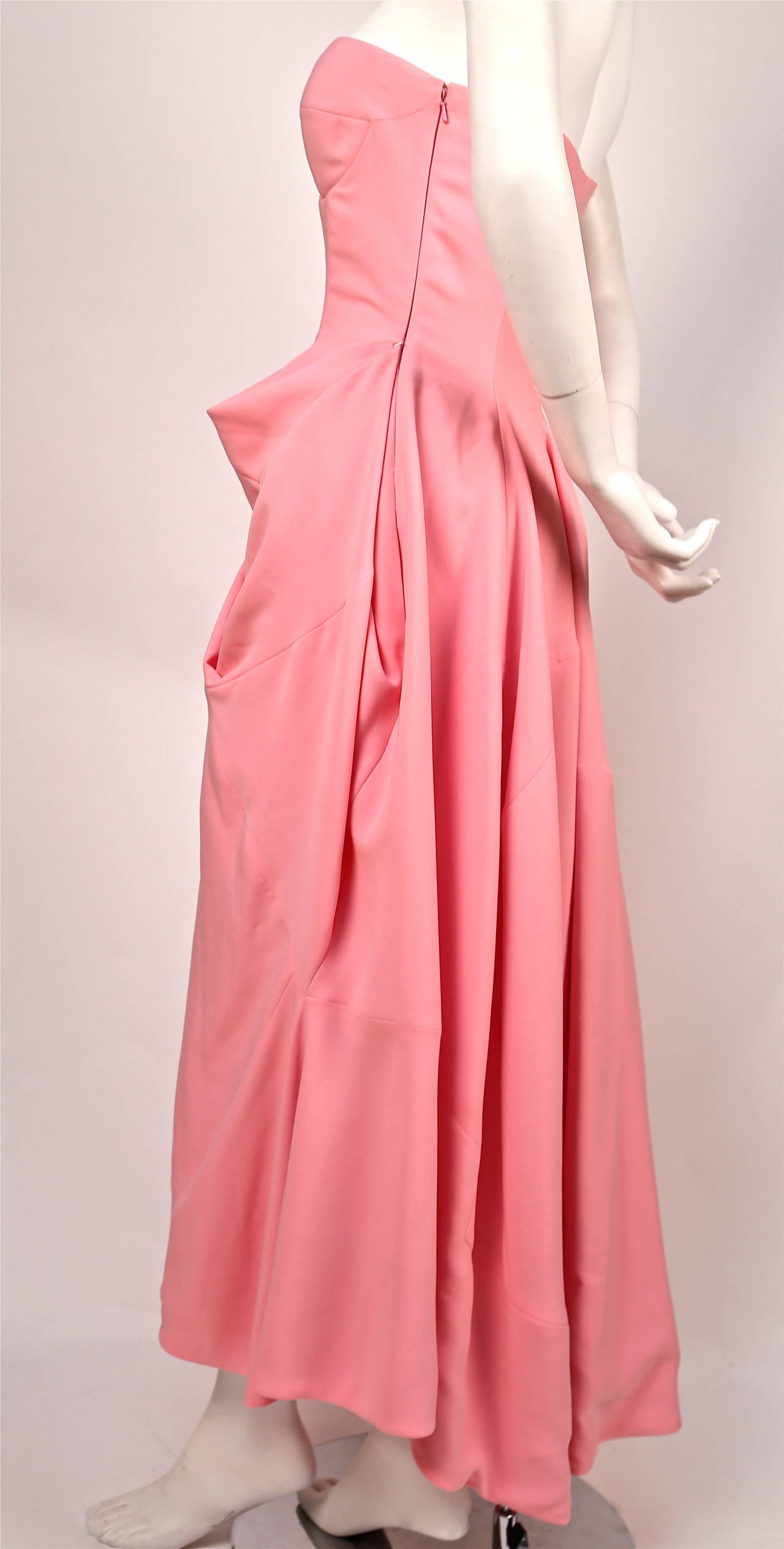 Very rare pink strapless bustier dress with very unique seaming and draped side detail designed by Raf Simons for Jil Sander exactly as seen on the runway for fall 2012. Finale piece. German size 36 which fits a US 4. Approximate measurements: bust