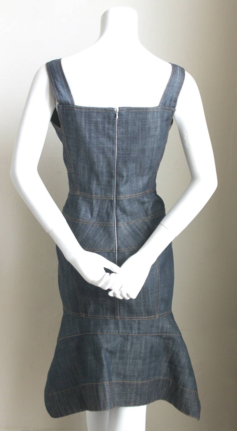 Very unusual rigid blue denim dress with intricate seaming and topstitching from Azzedine Alaia dating to 2006. Labeled a size large however this dress is very small and would best fit a US 6. Approximate measurements are: bust 34