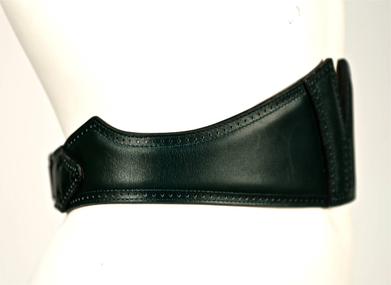 Forest green leather corset belt with punched dot detail from Azzedine Alaia dating to fall of 1992 as seen on the runway. Belt can be worn with the buckle in front or back. It was shown on the runway with the buckle in front.  French size 70.