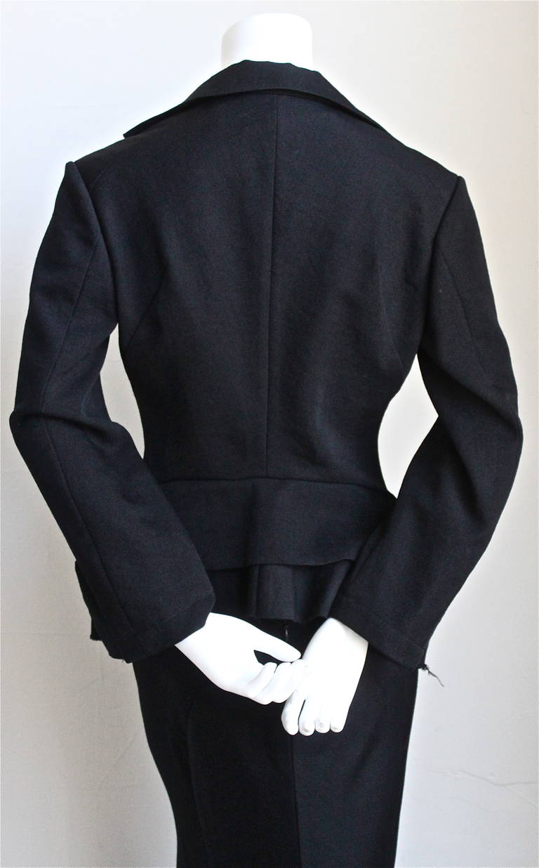 Black wool Victorian style suit jacket with bustle and bias cut skirt with raw edges by Junya Watanabe for Comme des Garcons dating to Fall of 2002. Jacket and skirt look great worn as separates as well. Both pieces are labeled size 'S'. Approximate