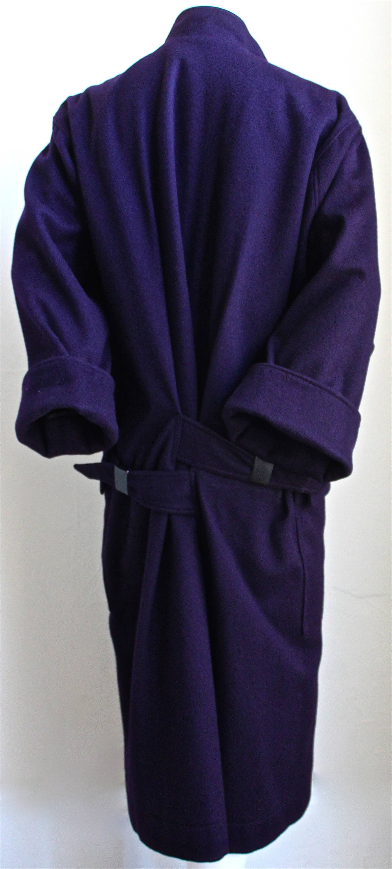 Very rare deep plum wool coat with unique adjustable metal buckles at back from Azzedine Alaia dating to the mid 1980's. No size is indicated however due to the oversized cut this coat can be worn by a size 6 up to a size 10. Approximate