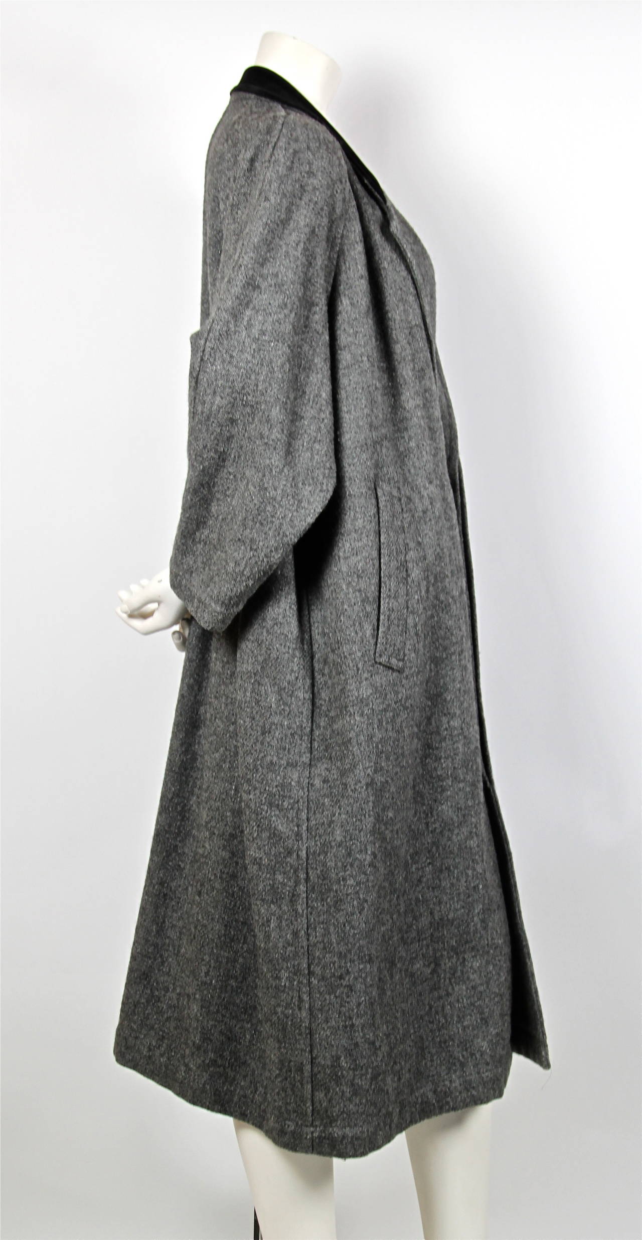 Men's style charcoal wool coat with velvet neckline and hidden buttons from Comme Des Garcons dating to the 1980's. Oversized cut. Approximate measurements: bust  50
