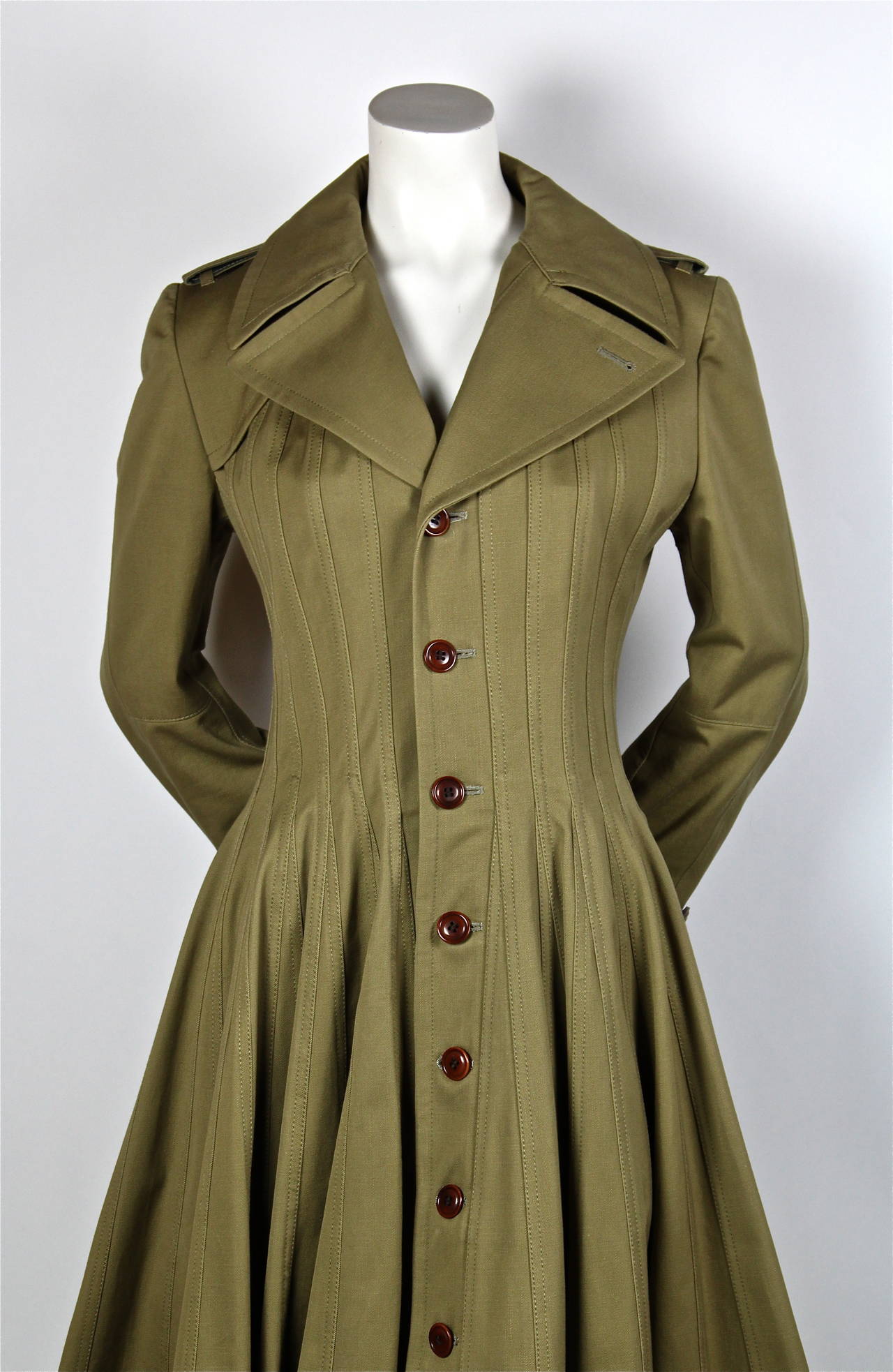 Khaki seamed 'Victorian' cut trench coat from Junya Watanabe for Comme Des Garcons exactly as seen on the runway for fall of 2010. Cotton gaberdine. Size M. Approximate measurements: shoulder 16