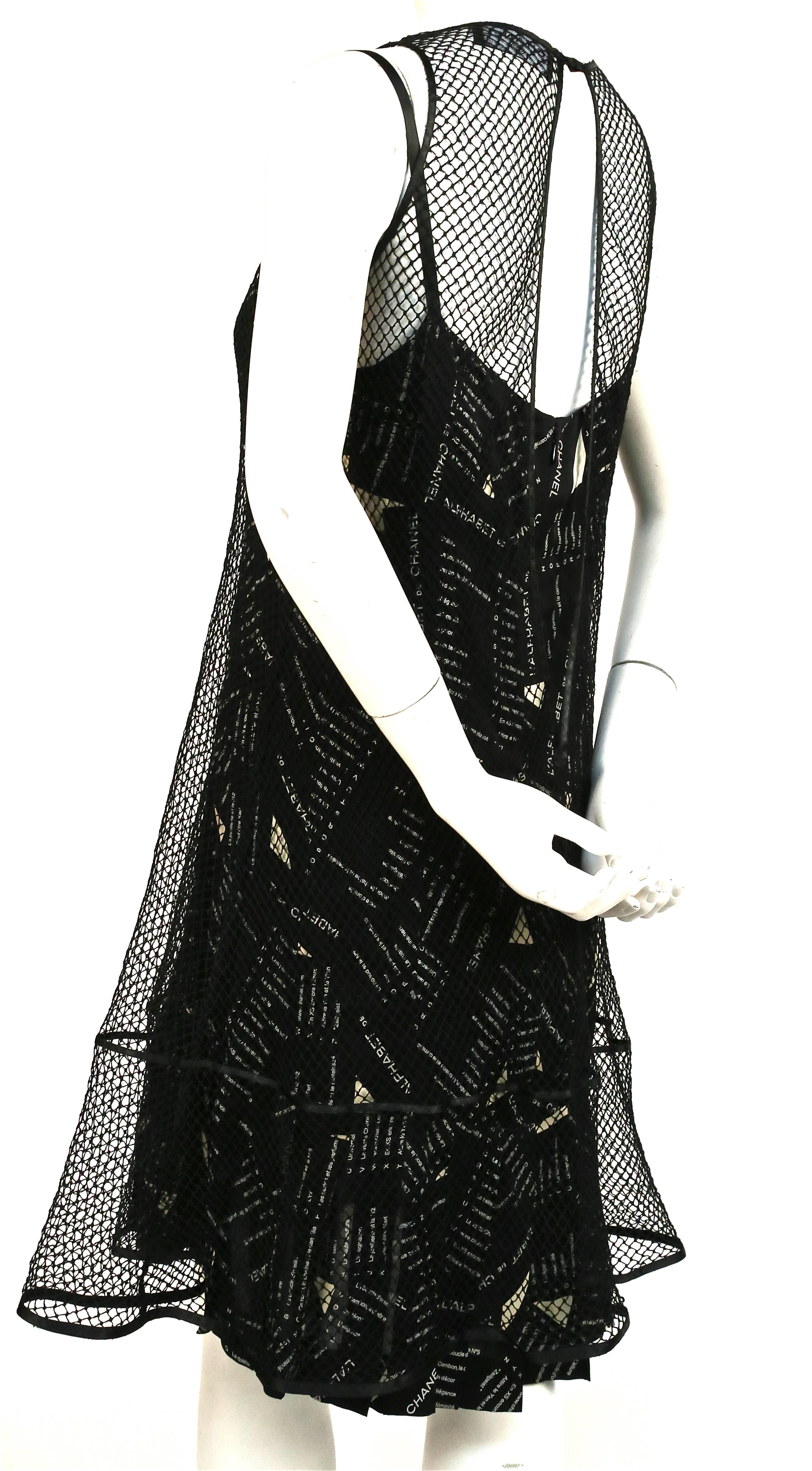 Very rare black and cream printed silk dress with sheer net overlay from Chanel exactly as seen on the runway for fall of 2005. French size 38. Approximate measurements are: bust 34