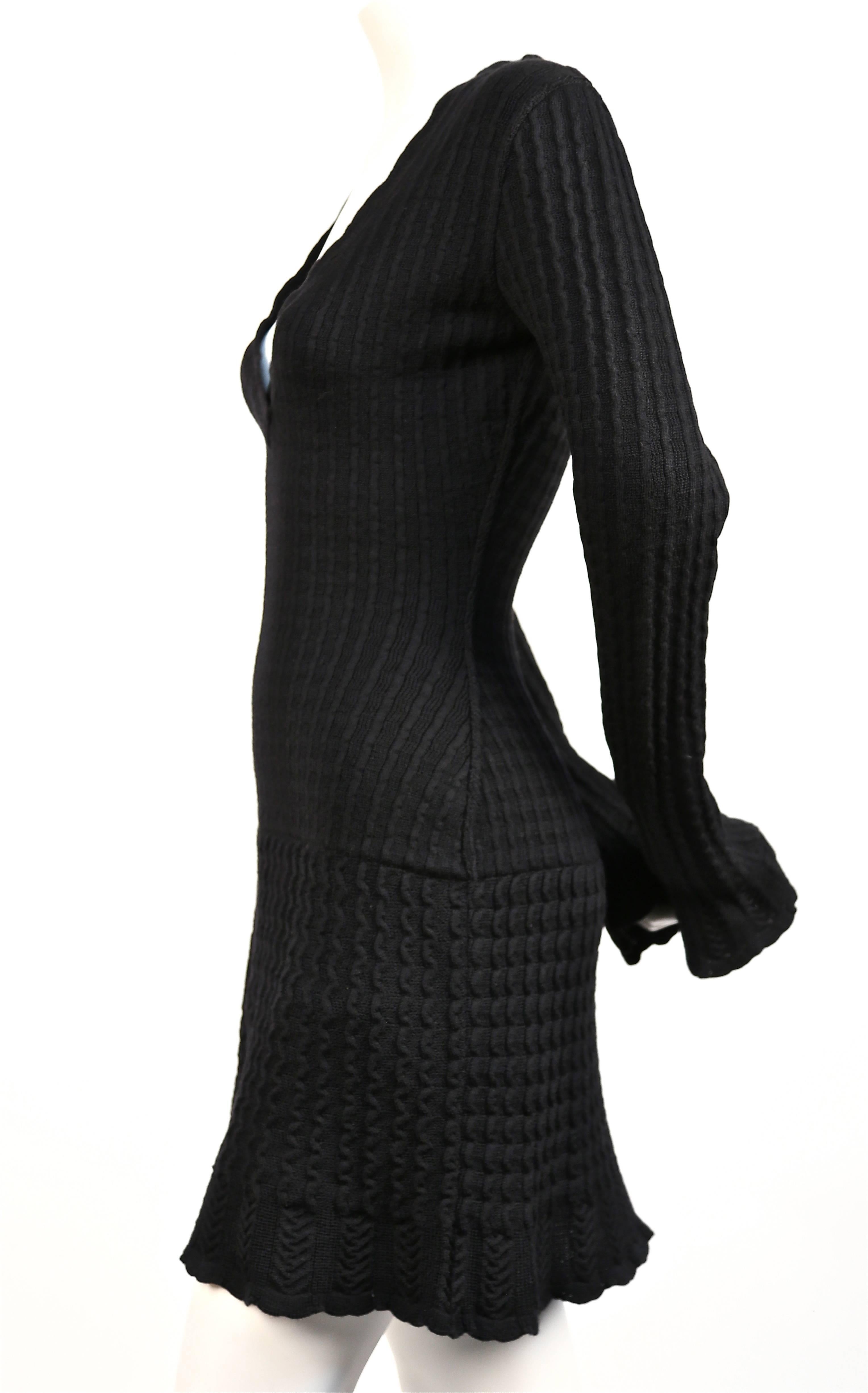 Classic jet black knit wool dress with crocheted detail from Alaia dating to the 1990's. Size 'S'. Approximate measurements: bust 32
