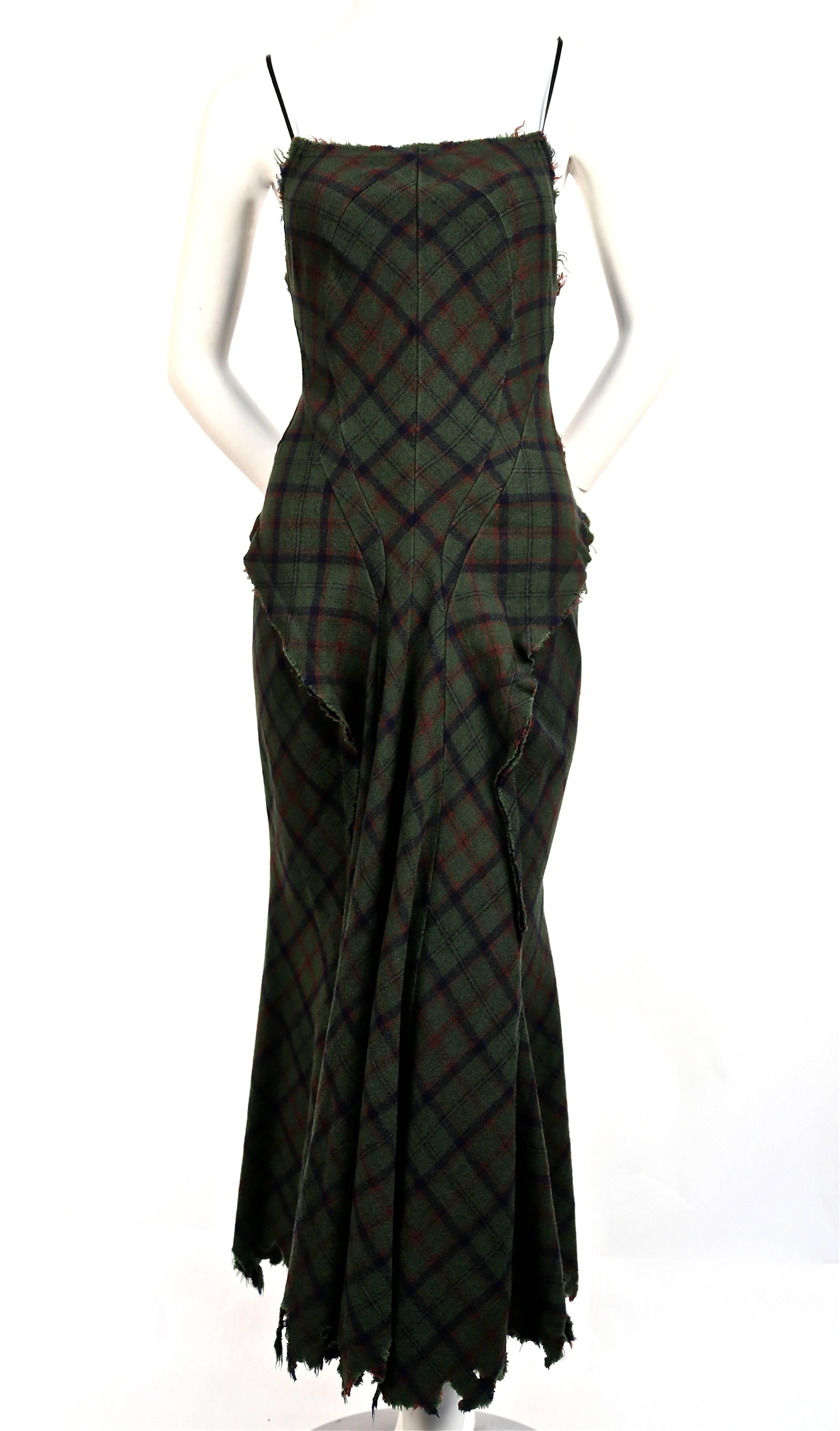 Green plaid bias cut intentionally tattered dress with cut out back by Junya Watanabe for Comme Des Garcons as seen on the ruwnay for fall of 2002. Frayed hemline. Leather spagetti straps. Labeled a size 'M' but also fits a small. 100% wool. Zips