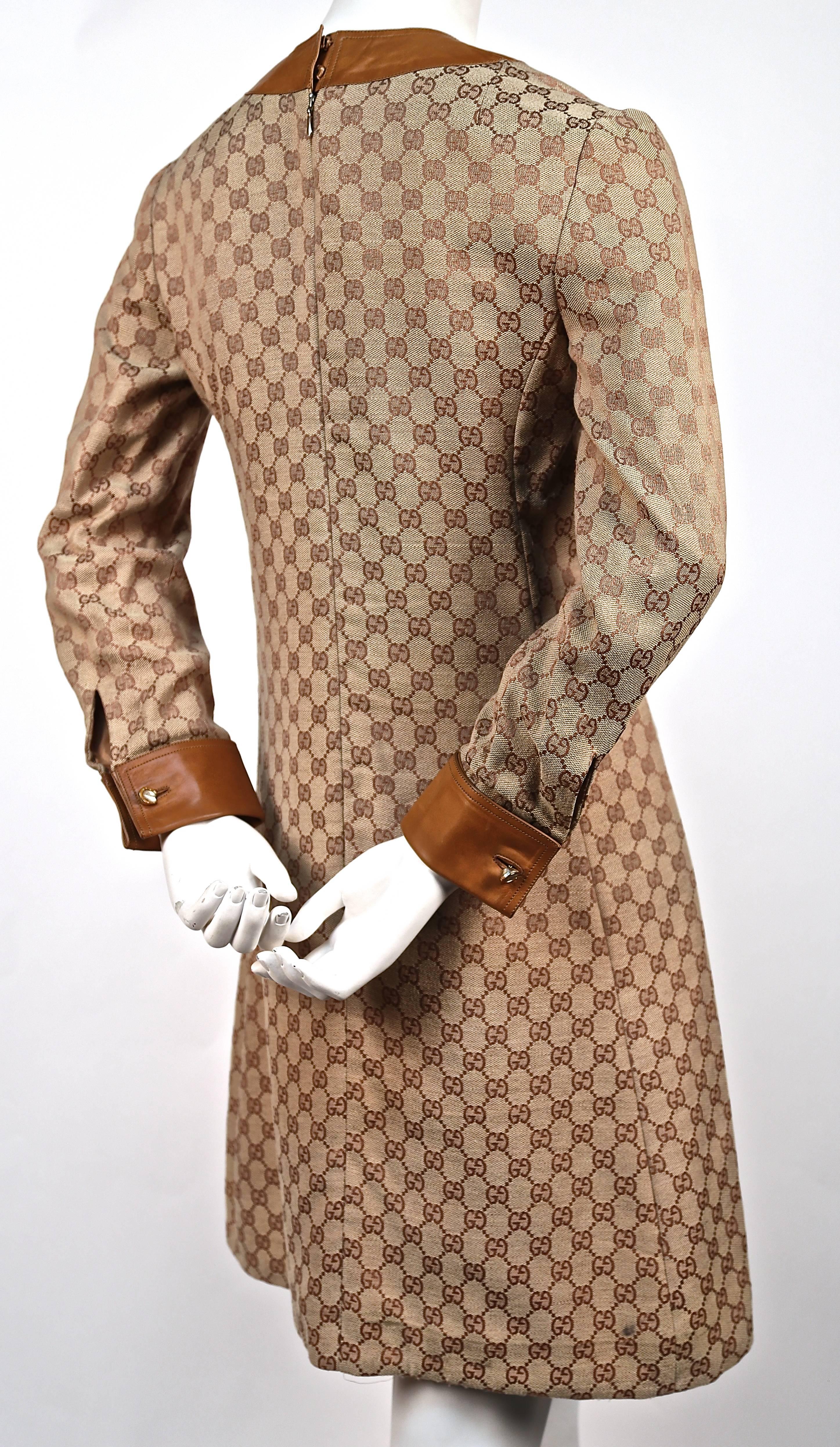 Very rare tan monogrammed canvas dress trimmed with leather and detailed silver-gilt horseshoe hardware from Gucci dating to the 1970's. Each horseshoe stamped Gucci 800. Dress labeled a size '2', which best fits a US 2 or 4. Made in Italy. Fully