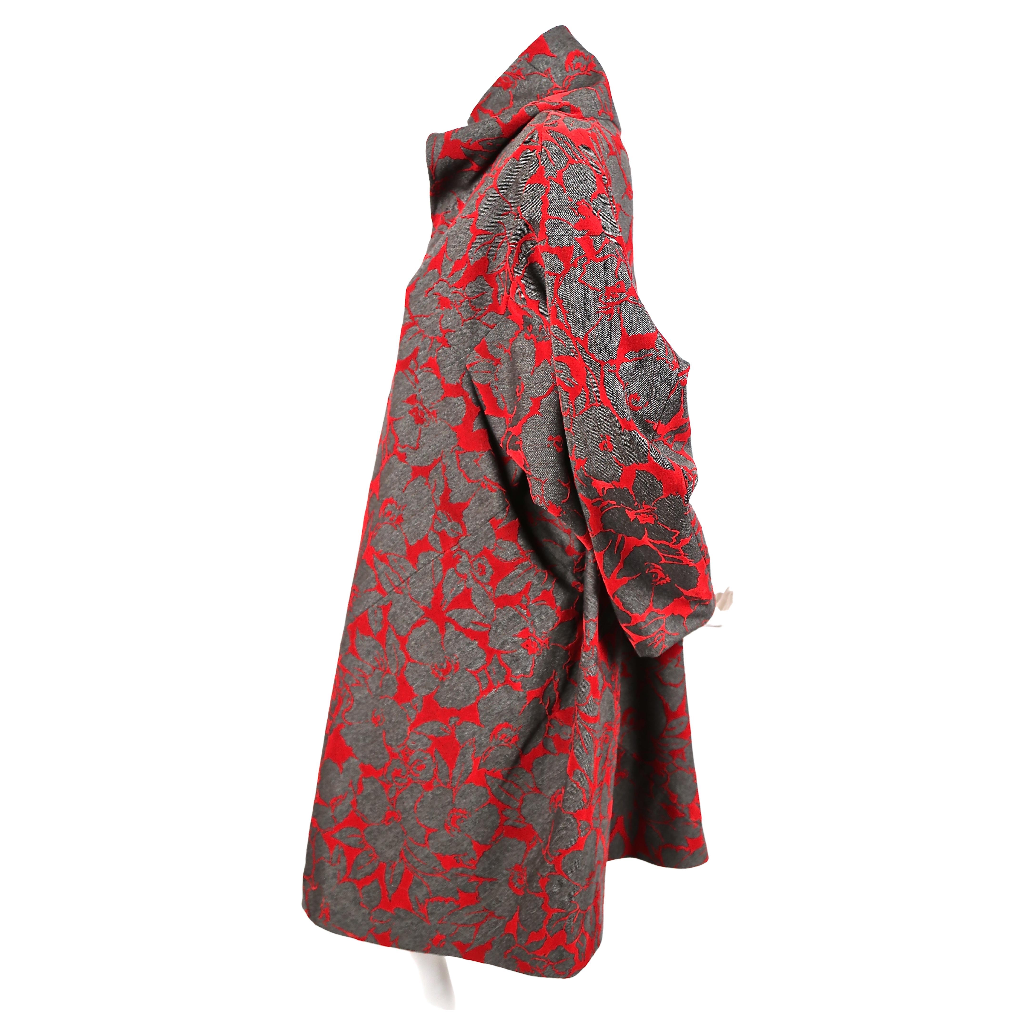 Charcoal, herringbone woven wool dress with clever reverse red flocking which creates beautiful floral outlines from Comme Des Garcons as seen exactly on the runway for fall of 1996. Labeled a size small however this dress will easily fit a medium