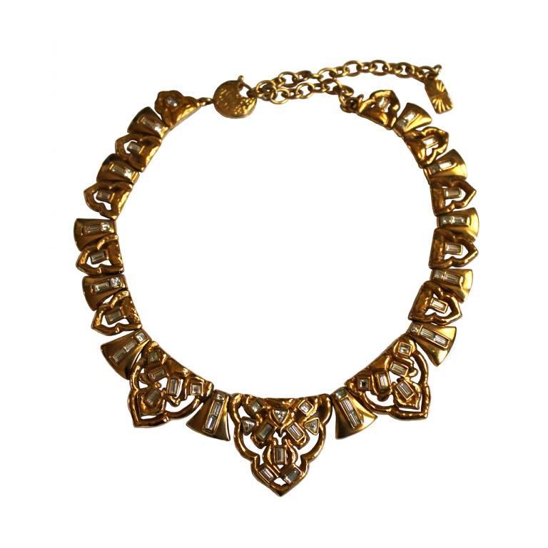 Glamorous gilt necklace with faceted crystals made by Robert Goossens for Yves Saint Laurent dating to the 1980's. Necklace is very detailed with dozens of clear faceted crystals. Necklace measures just over 20