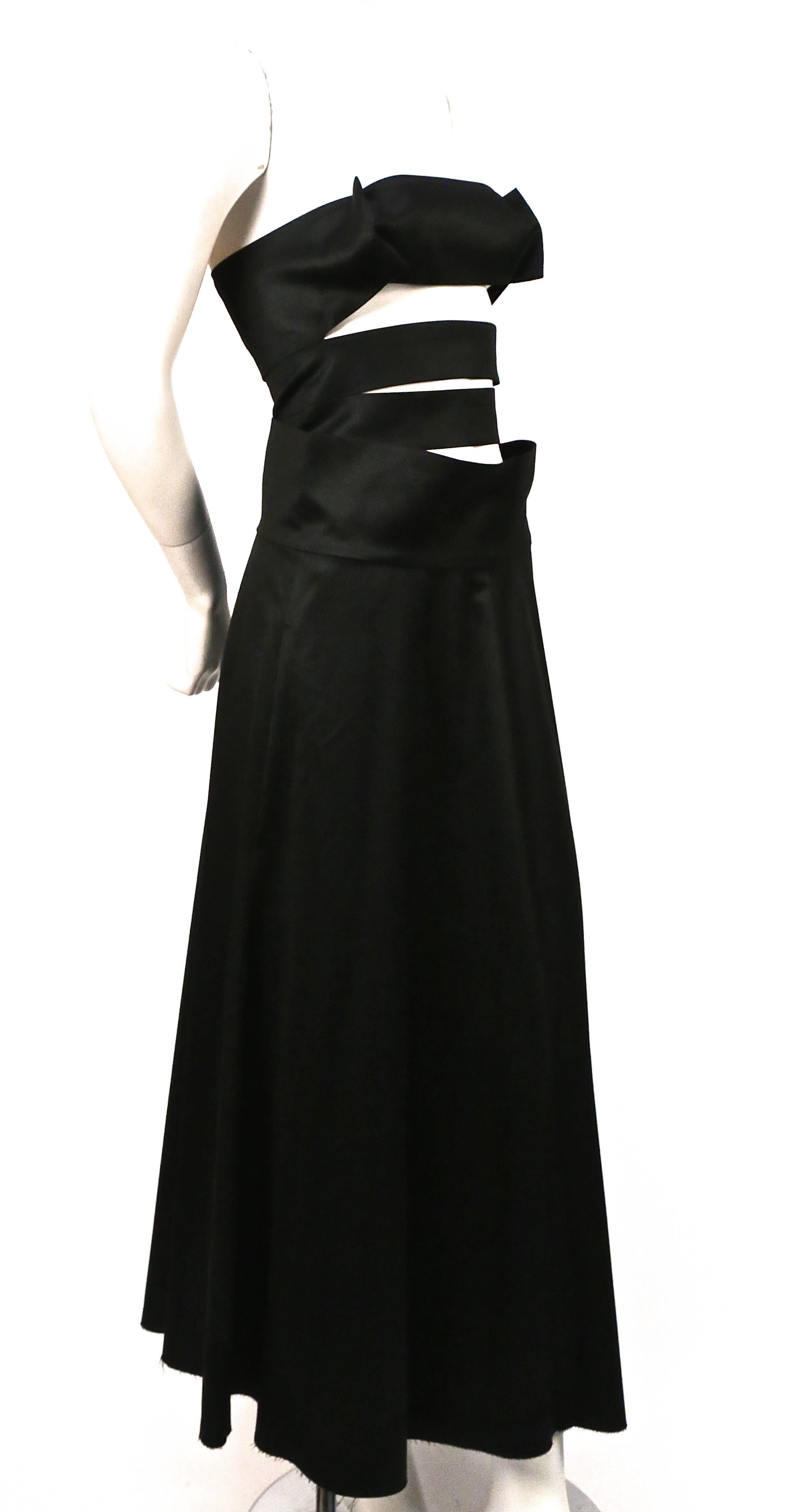Jet black strapless dress with unique cut out bodice from Yohji Yamamoto dating to spring 2003 exactly as seen on the runway.  Japanese size 1. Approximate measurements: bust 32" and length 49". Silver side zip closure. One hidden pocket