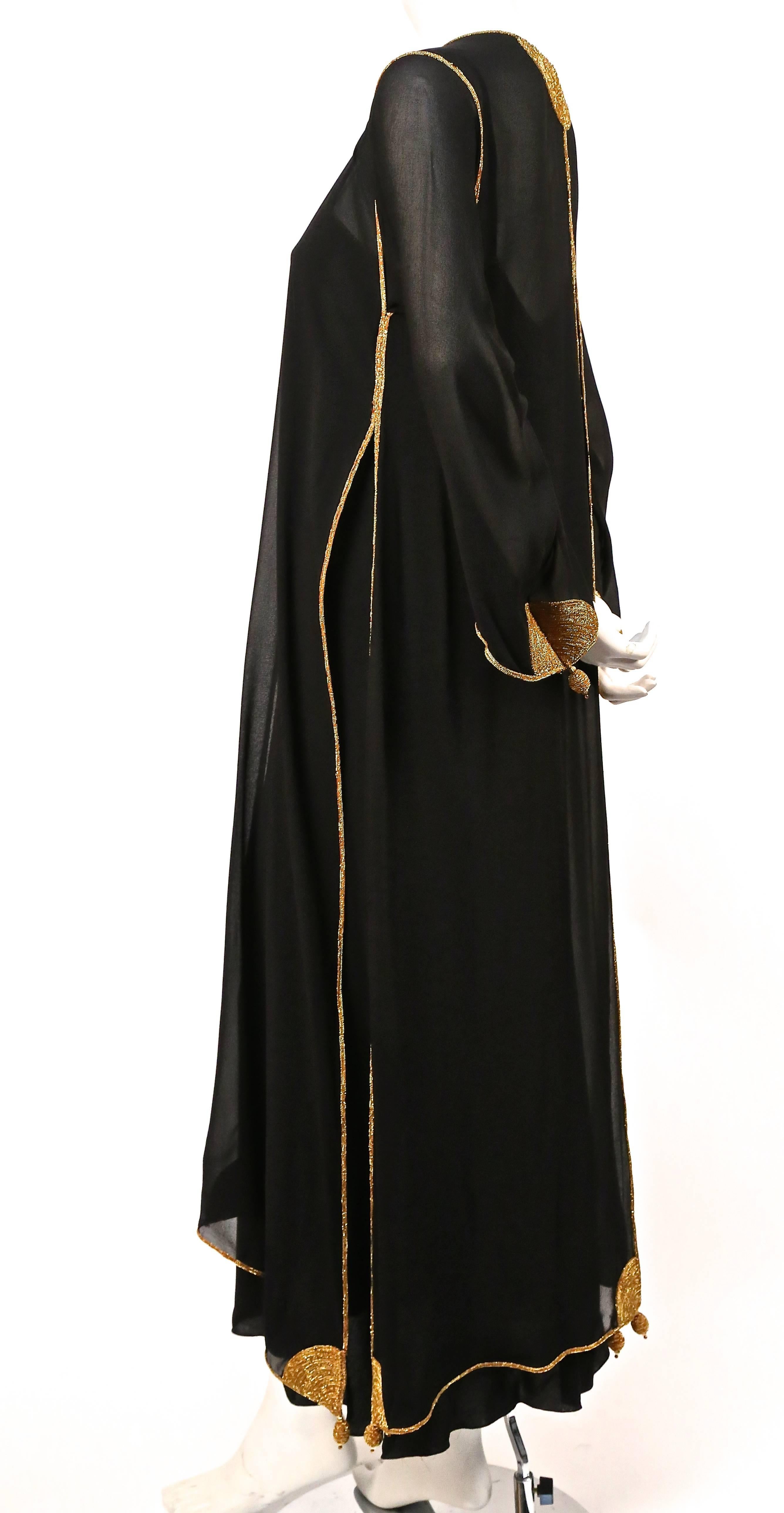 Jet black silk dress and kaftan jacket with decorative gold trim designed by Karl Lagerfeld for Chloe dating to the 1970's. Best fits a US 4-6. Approximate measurements (dress): bust 34