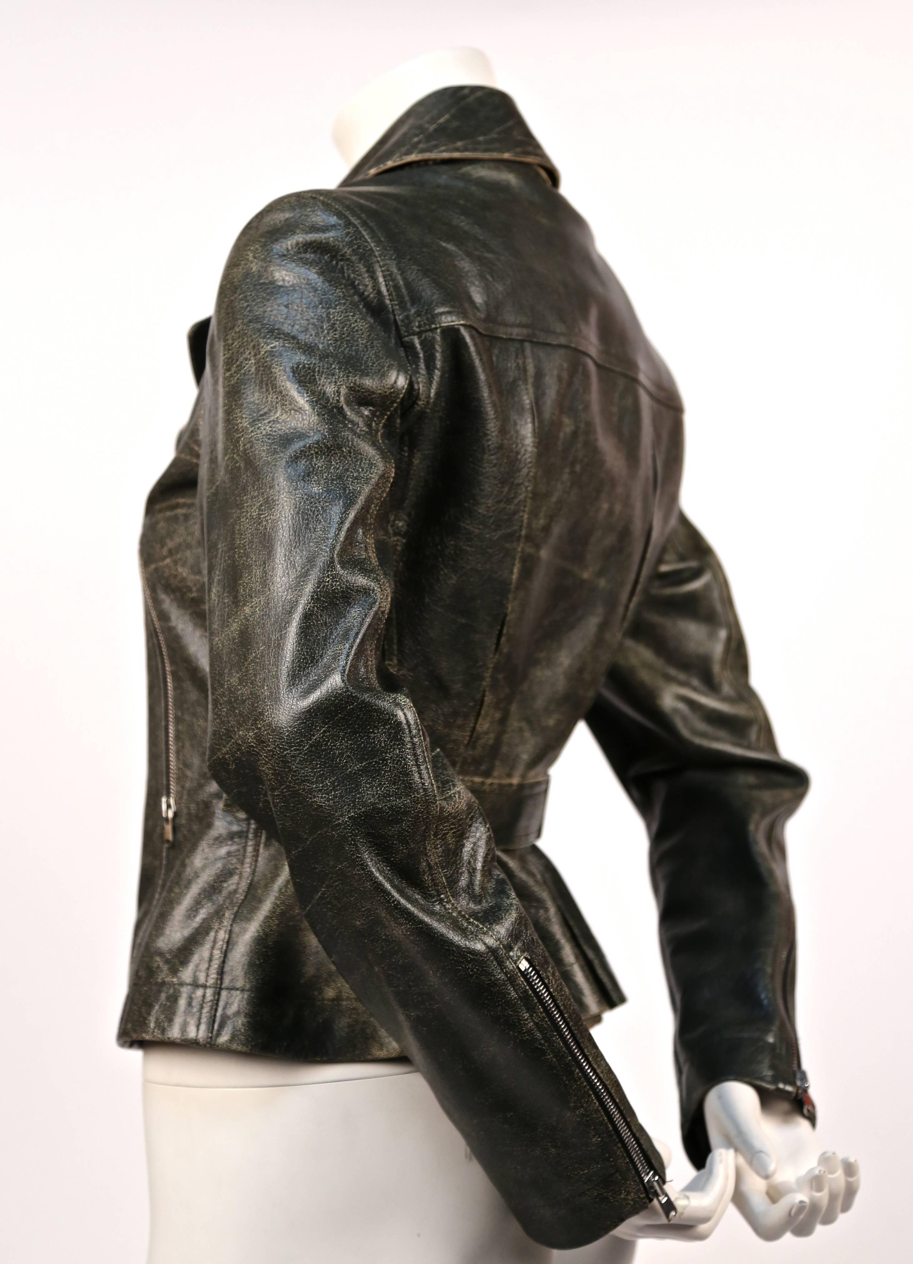 Classic motorcycle jacket made with unique dark khaki green distressed leather, silver hardware and lace up detail at back from Azzedine Alaia. French size 40, although this jacket runs small and best fits a FR 38. Approximate measurements:
