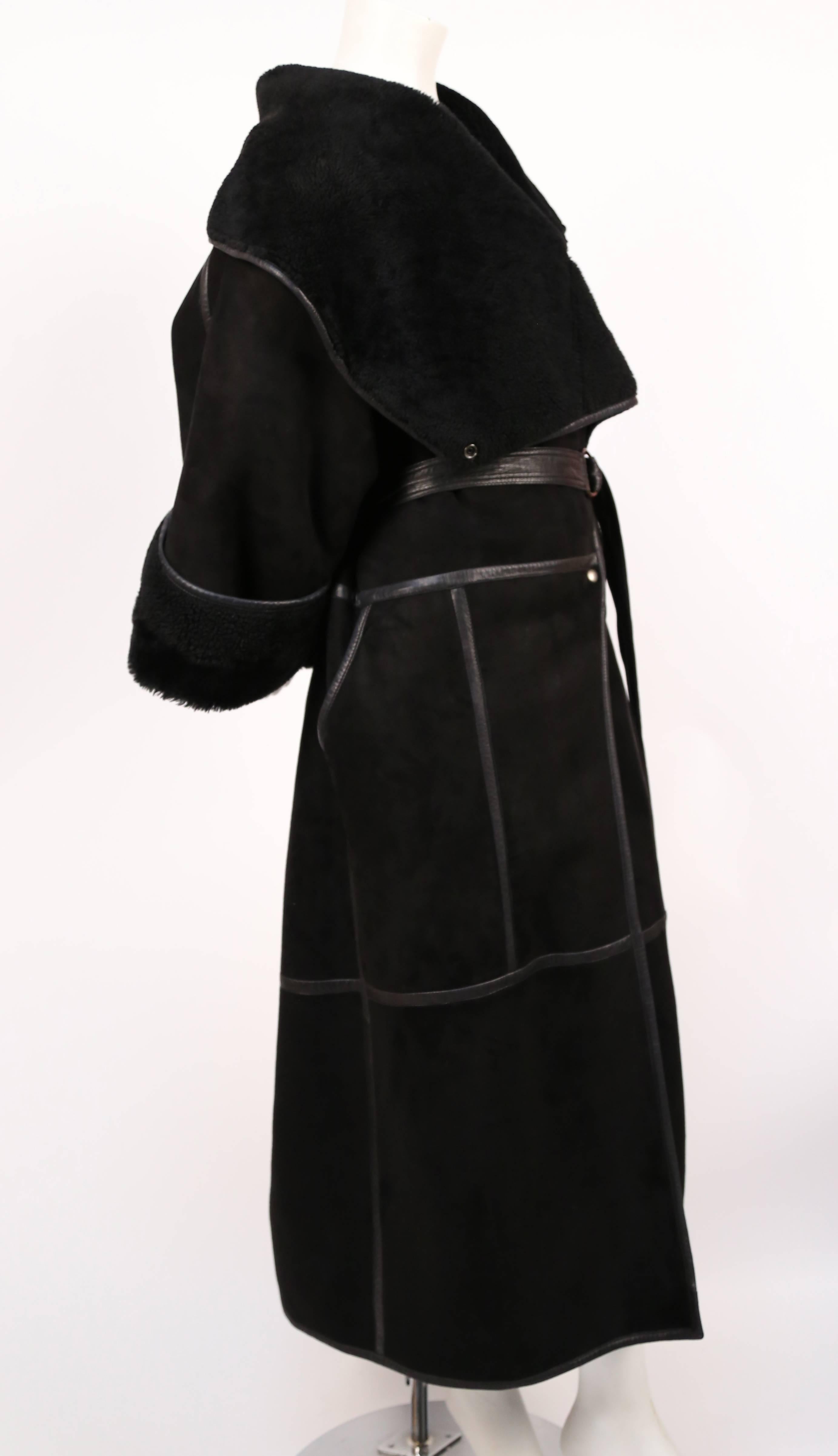 Very rare draped black shearling coat with leather trim by Anne Marie Beretta dating to the 1980's. Labeled a French size 38 however the coat has an oversized draped fit so it can fit a size or two larger depending on desired fit. Snap closure with