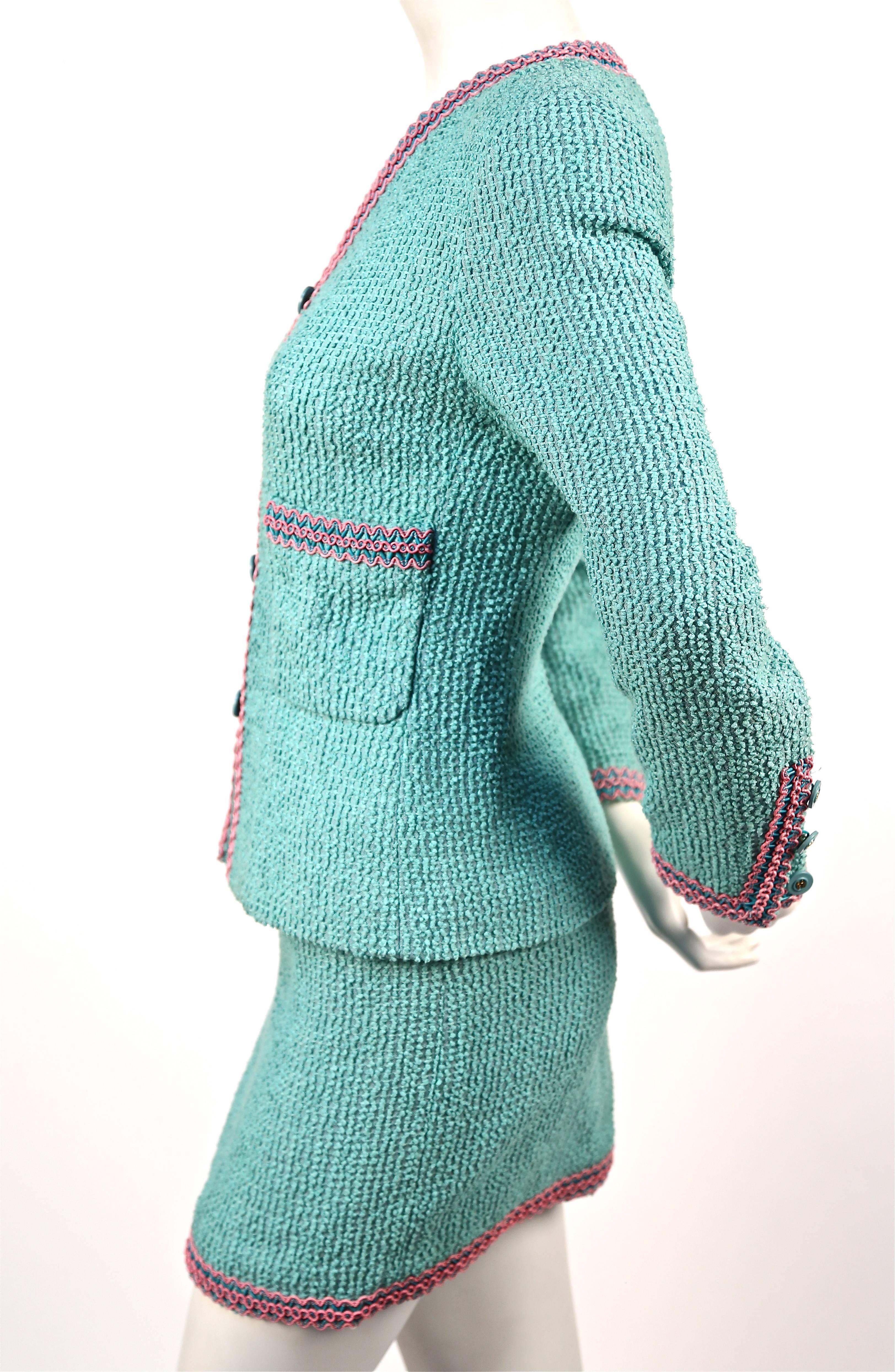 Very rare turquoise boucle 'Scoubidou' suit with braided plastic trim from Chanel as seen on the runway for Spring of 1994. Very well documented piece. French size 36. Approximate measurements for jacket: 15.5