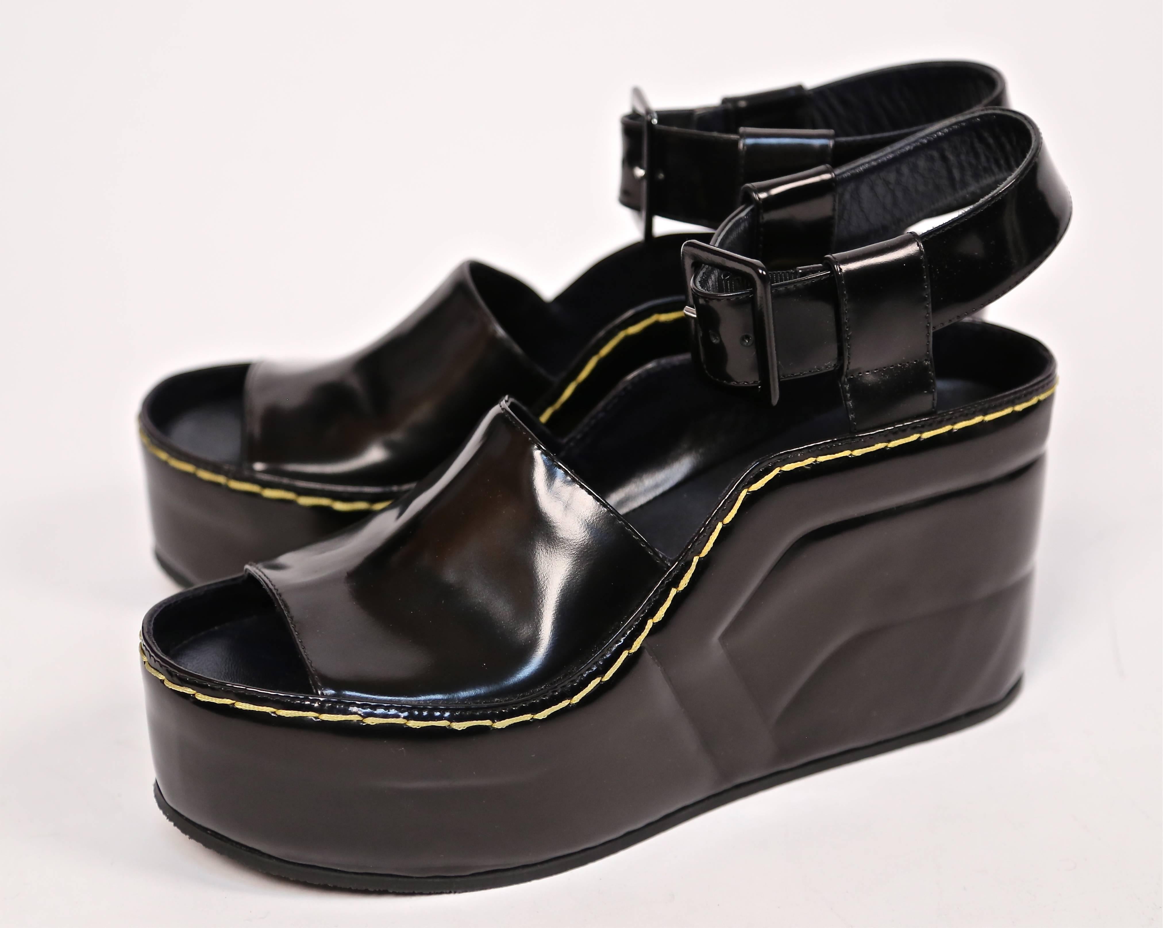  Black spazzolato leather wedge sandals with yellow top-stitching from Celine dating to fall 2014 as seen on the runway. Size 39. Insoles measure: 10.25