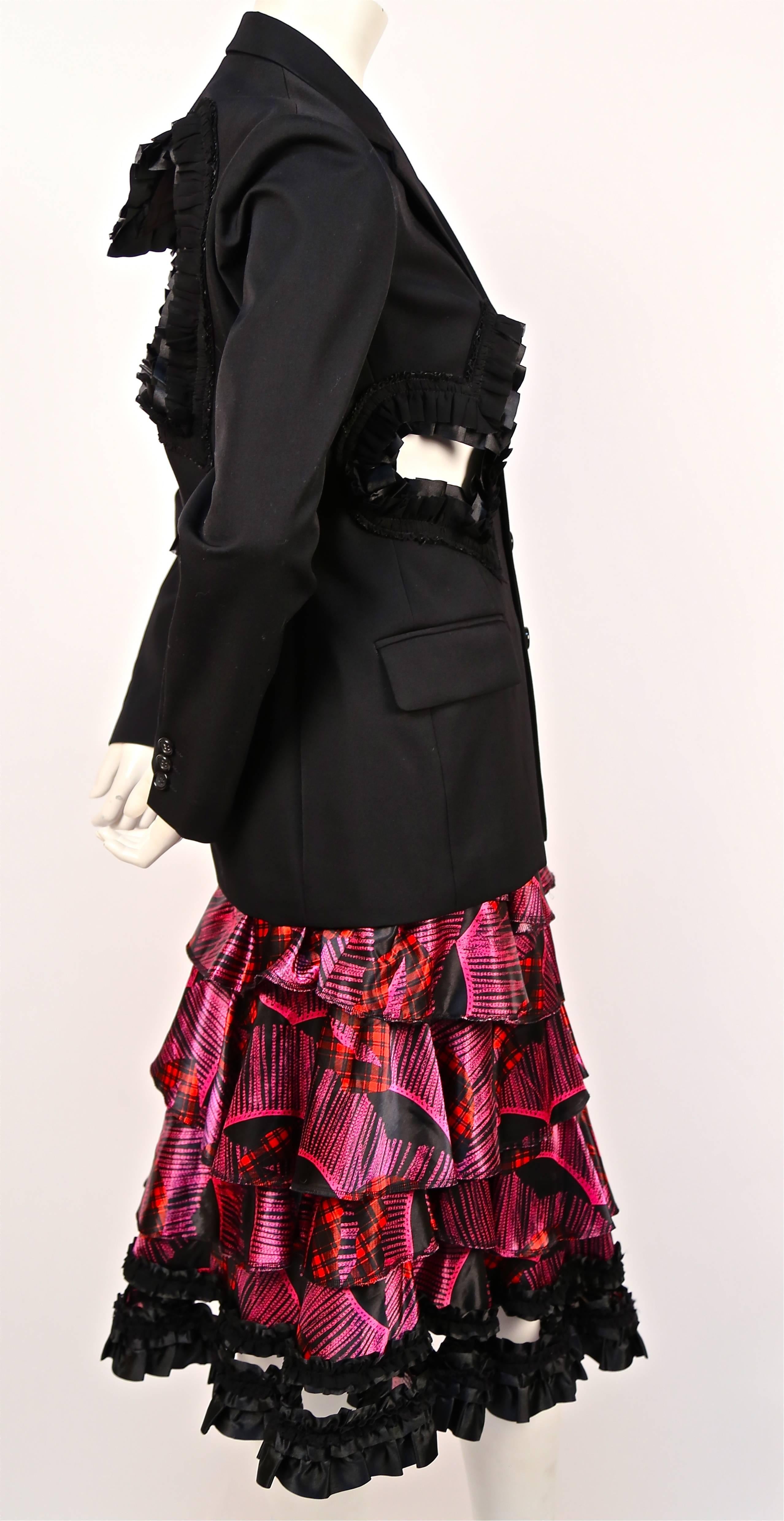 Very rare jet black blazer with cut out hearts and ribbon trim paired with a printed tiered skirt by Comme Des Garcons as seen at the 'Bad taste' fall 2008 runway show. Both pieces are labeled a size 'S'. Jacket measures approximately: 15" at